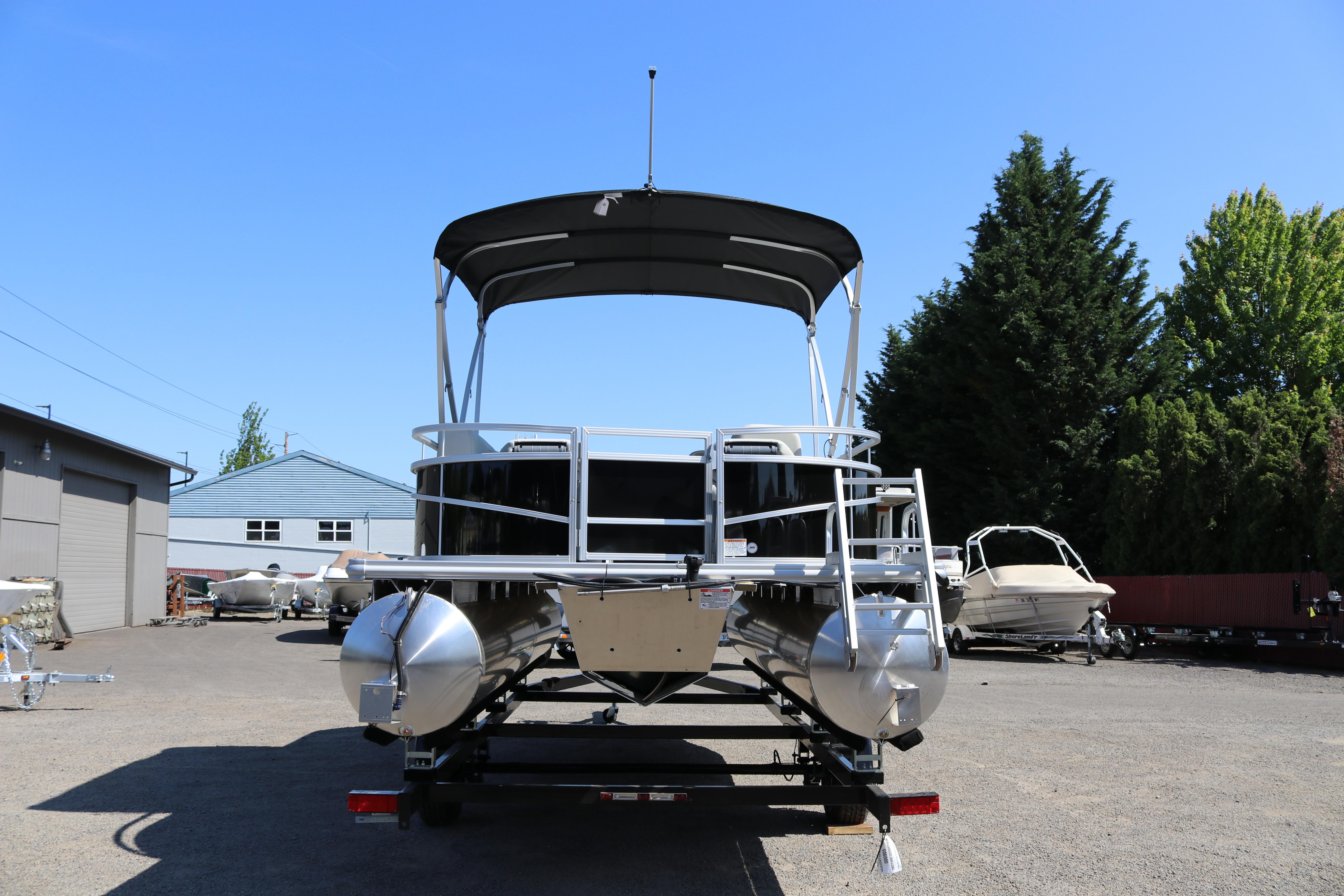 2025 SunChaser Vista 20 Fish pontoon boat parked outdoors on a sunny day.
