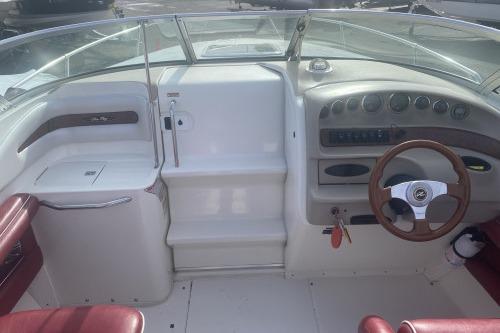 1997 Sea Ray 230 Overnighter boat cockpit with steering wheel and dashboard controls.