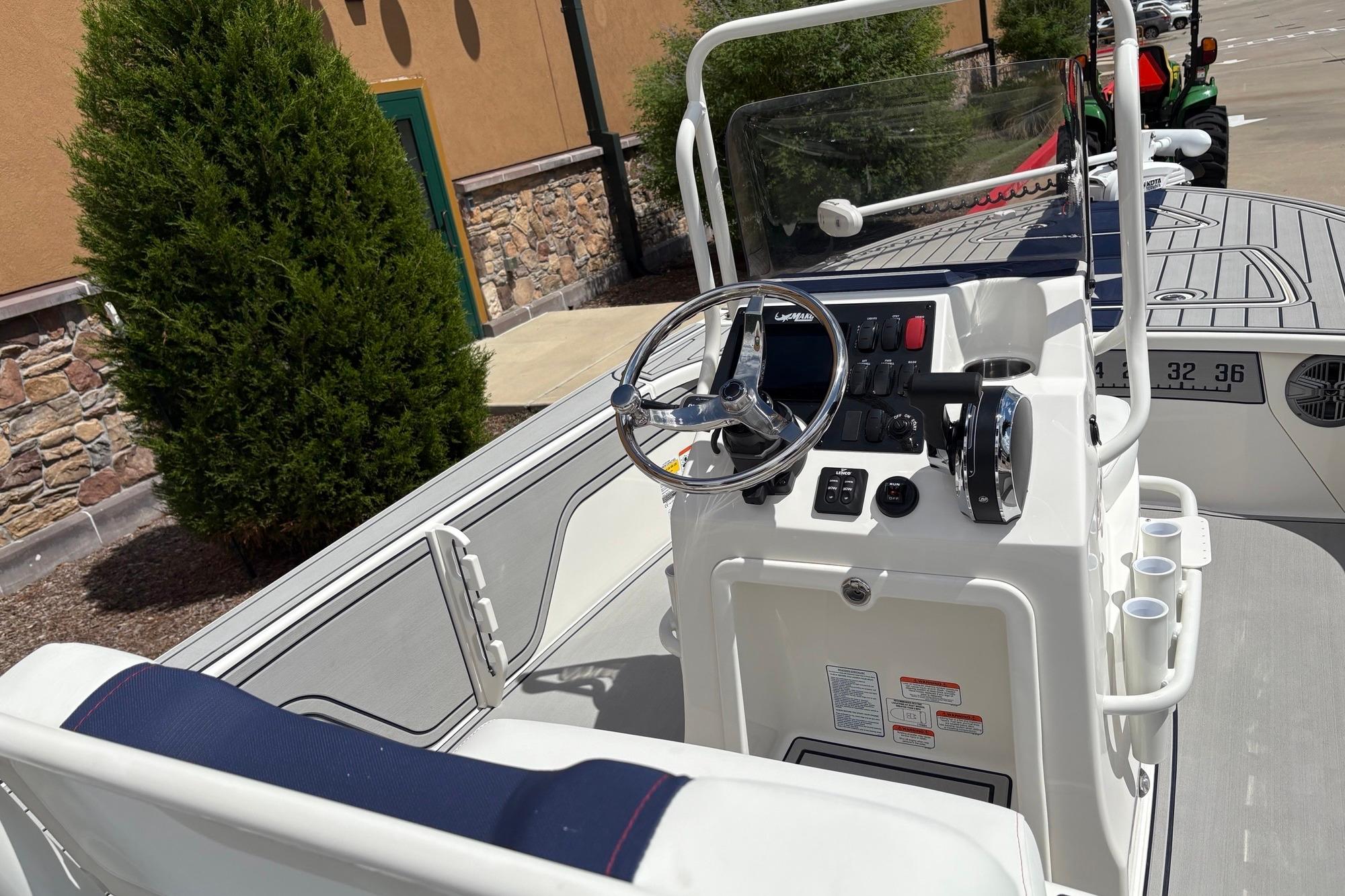 2026 Mako 18 Pro Skiff Patriot Edition boat interior with steering console and controls.