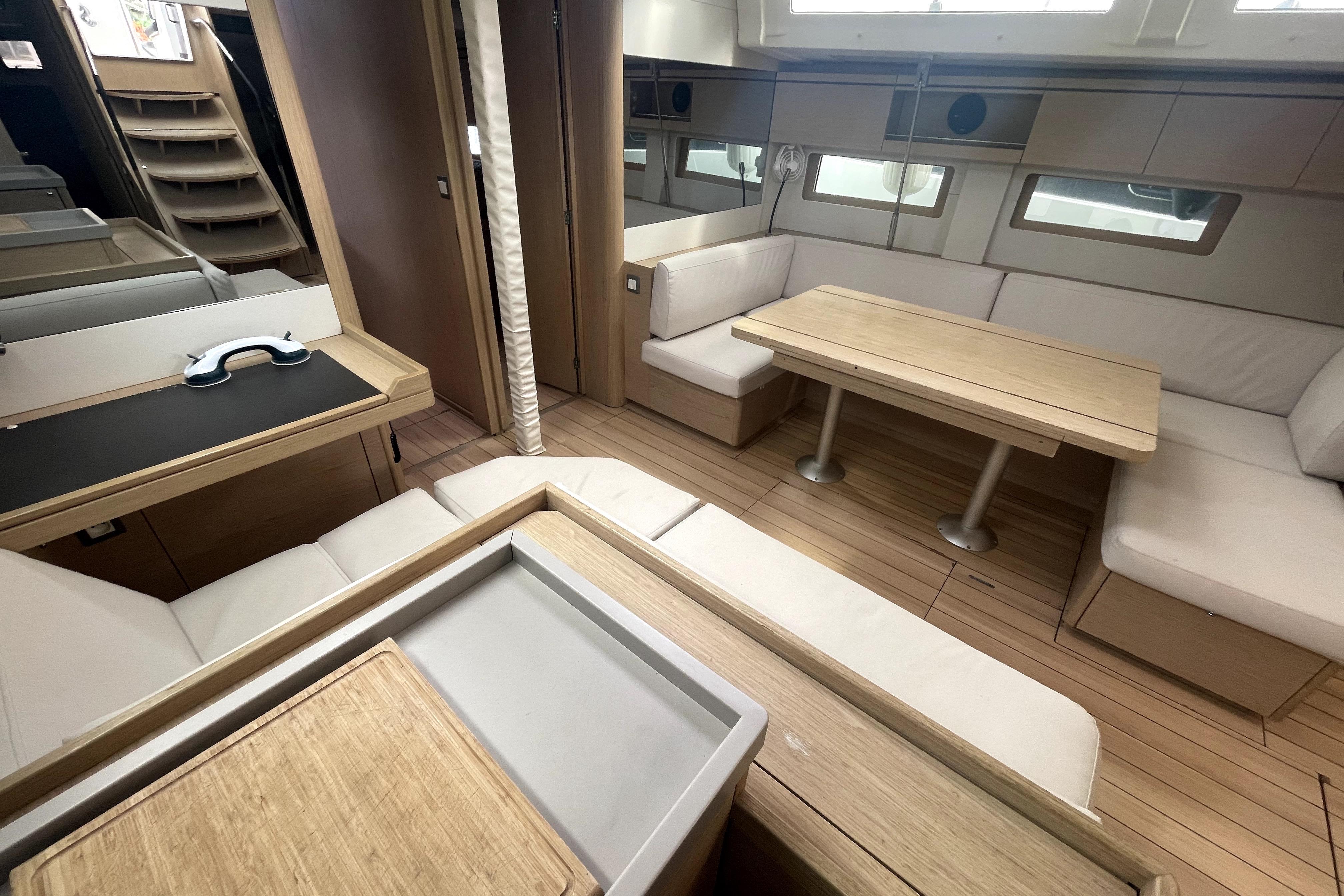 Luxurious interior of 2018 Beneteau Oceanis 51.1 yacht with modern seating and dining area.