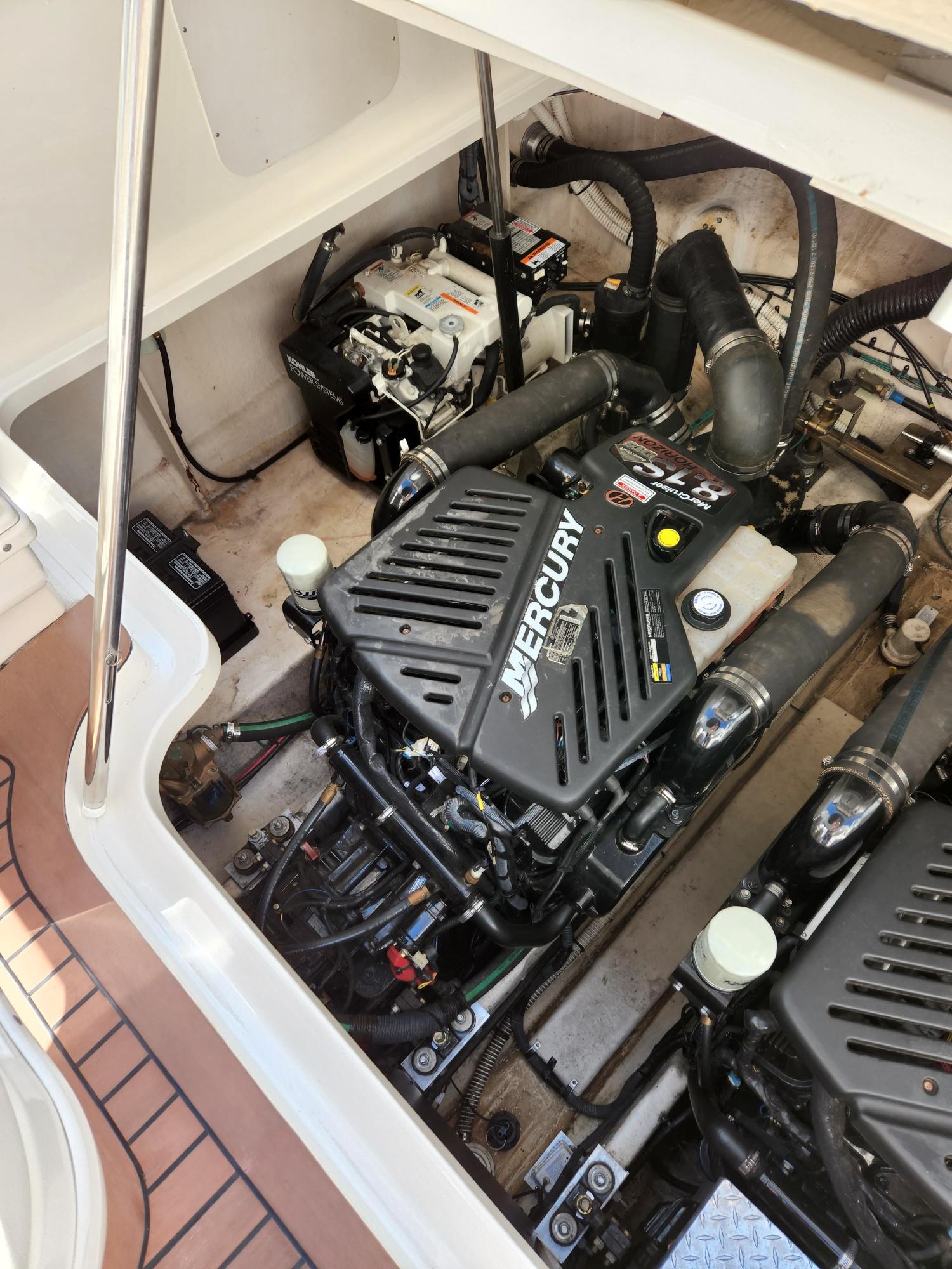 Engine compartment of a 2005 Sea Ray 340 Sundancer with Mercury engine components.