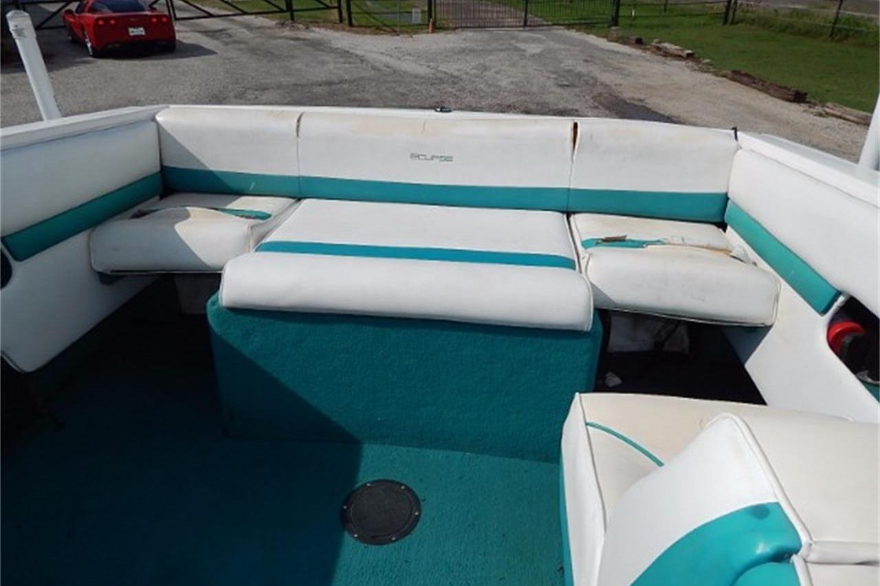 1991 Wellcraft Eclipse 232 boat interior with white and teal seating.