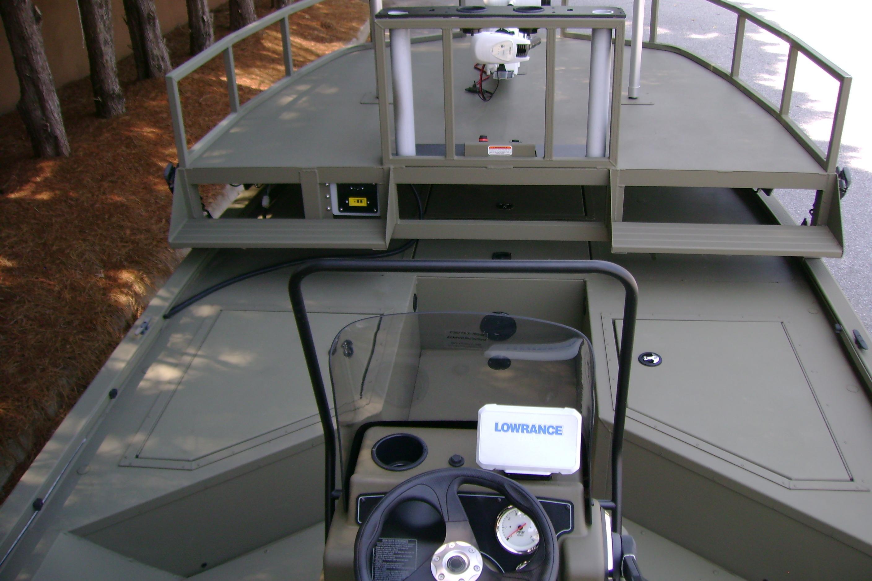 2026 Tracker Grizzly 2072 CC Sportsman boat interior with steering console and equipment.