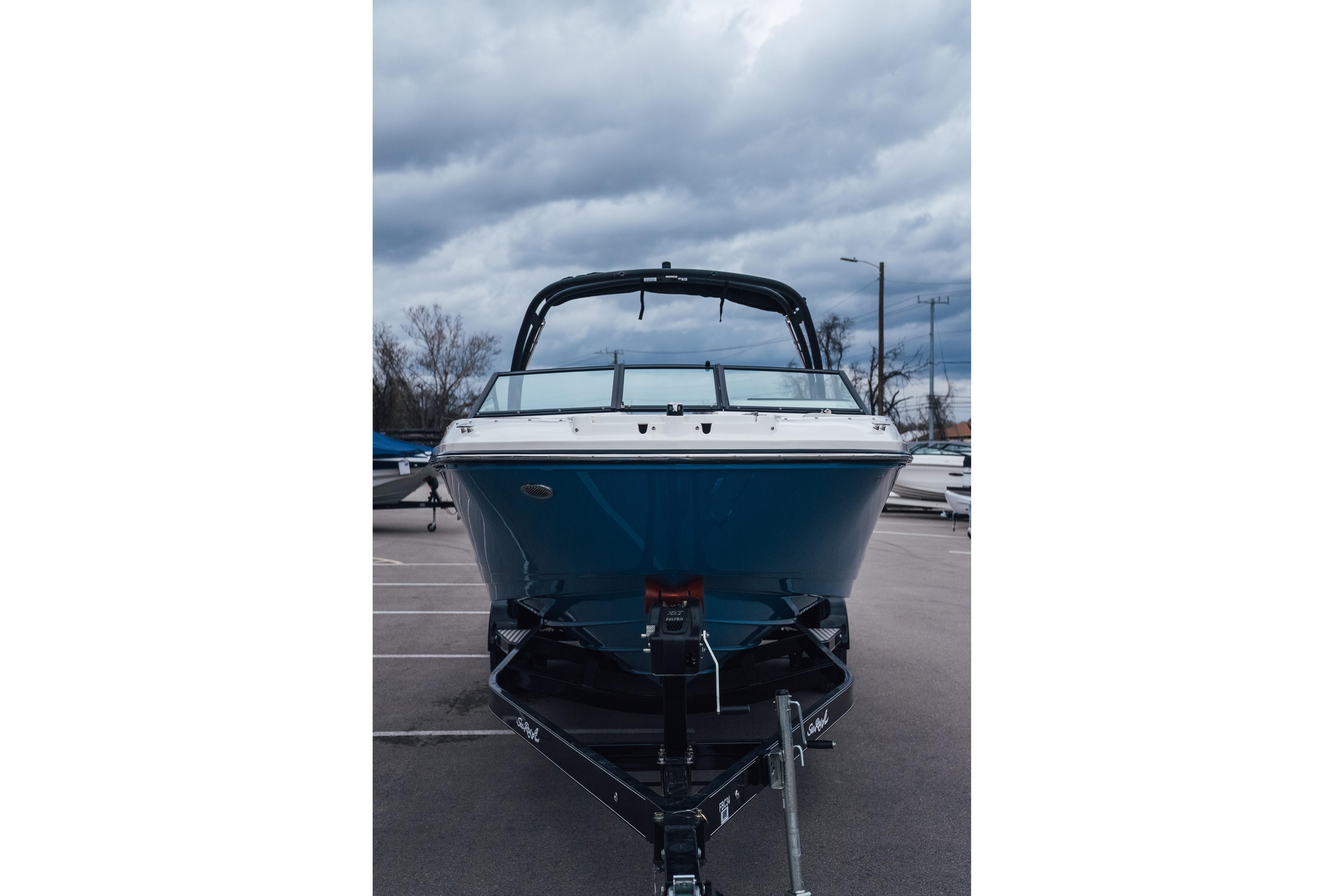 2023 Sea Ray SPX 230 boat on trailer under cloudy sky.