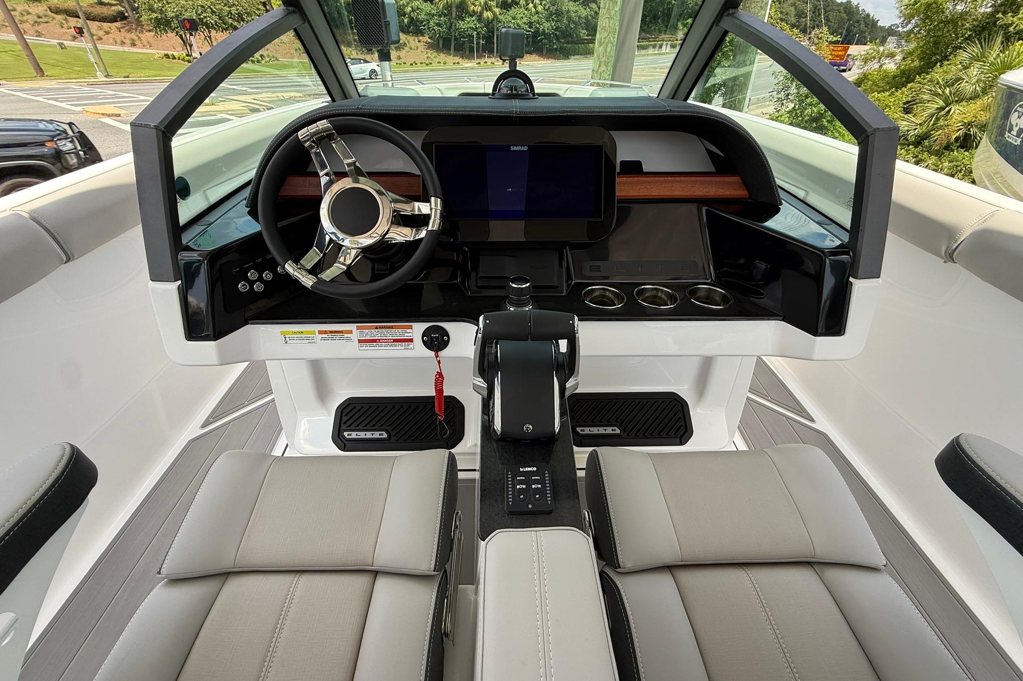 Cockpit of 2027 Monterey Elite 30 OB boat with modern steering and dashboard controls.