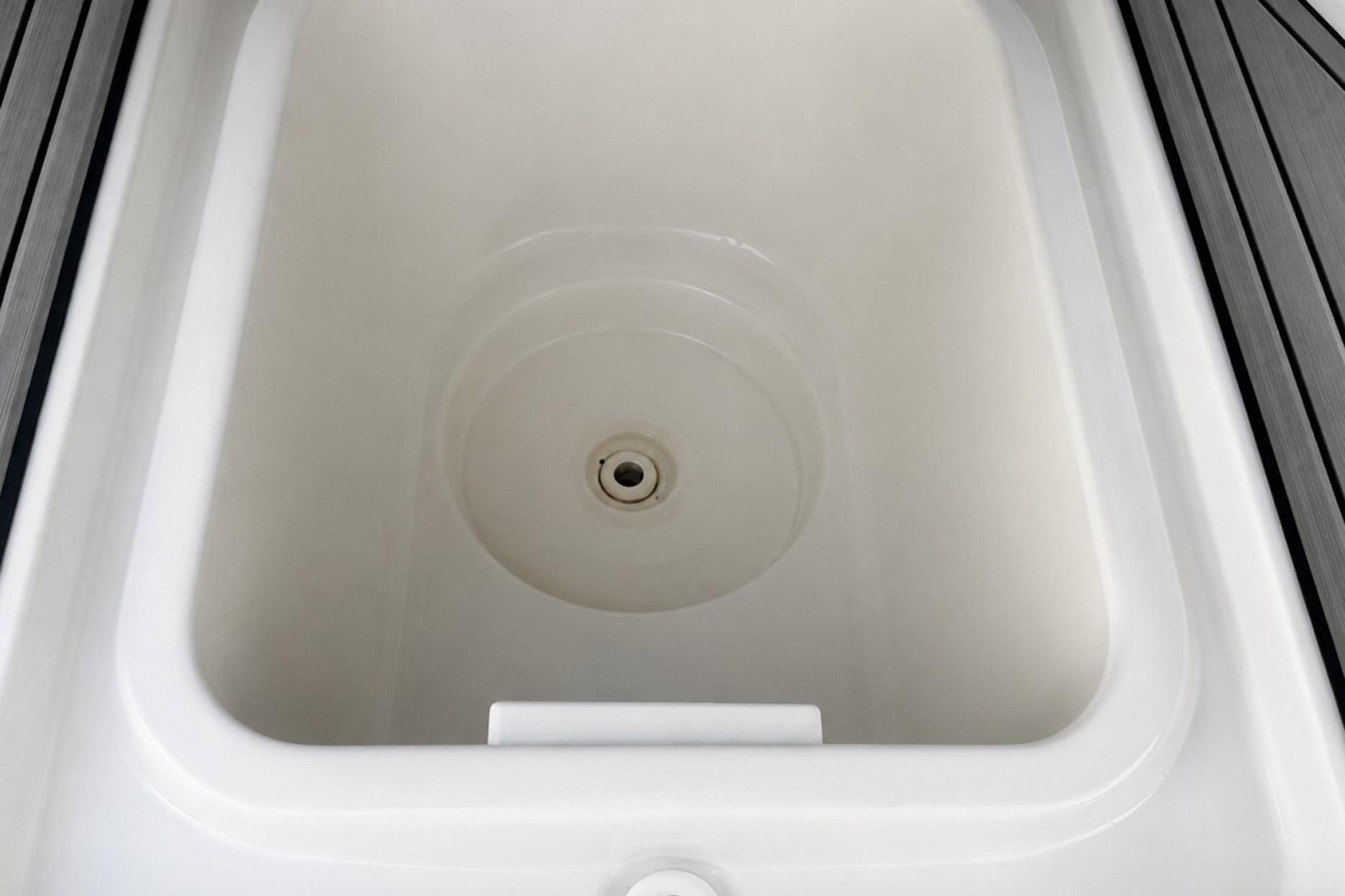 Storage compartment of a 2002 Sea Fox 228 Commander boat, featuring a clean, white interior.