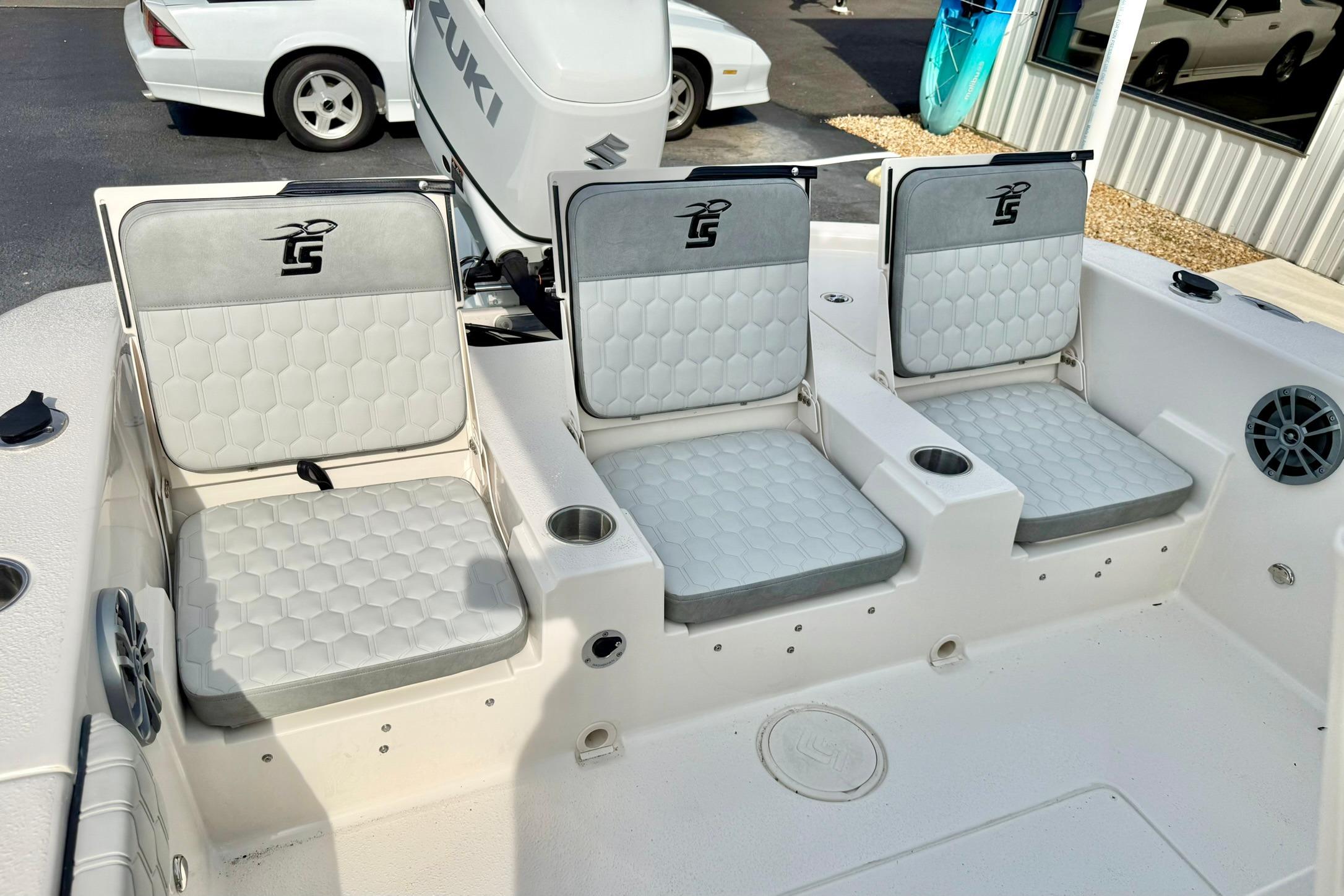 2026 Carolina Skiff 24 Ultra Elite boat seating with Suzuki engine, featuring comfortable cushions.