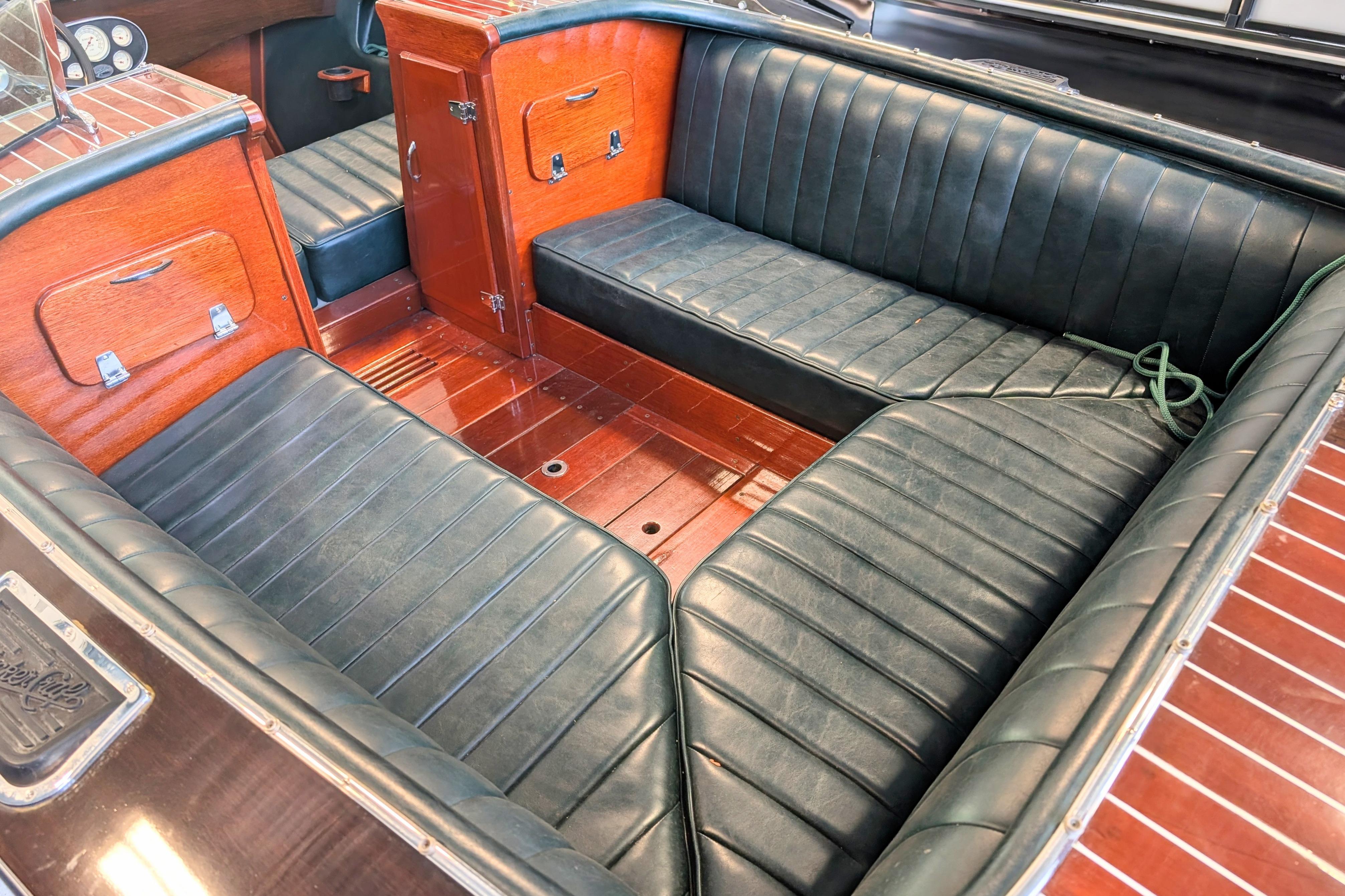 Interior of a 2001 Hacker-Craft 24 Dual Console with leather seating and wooden accents.