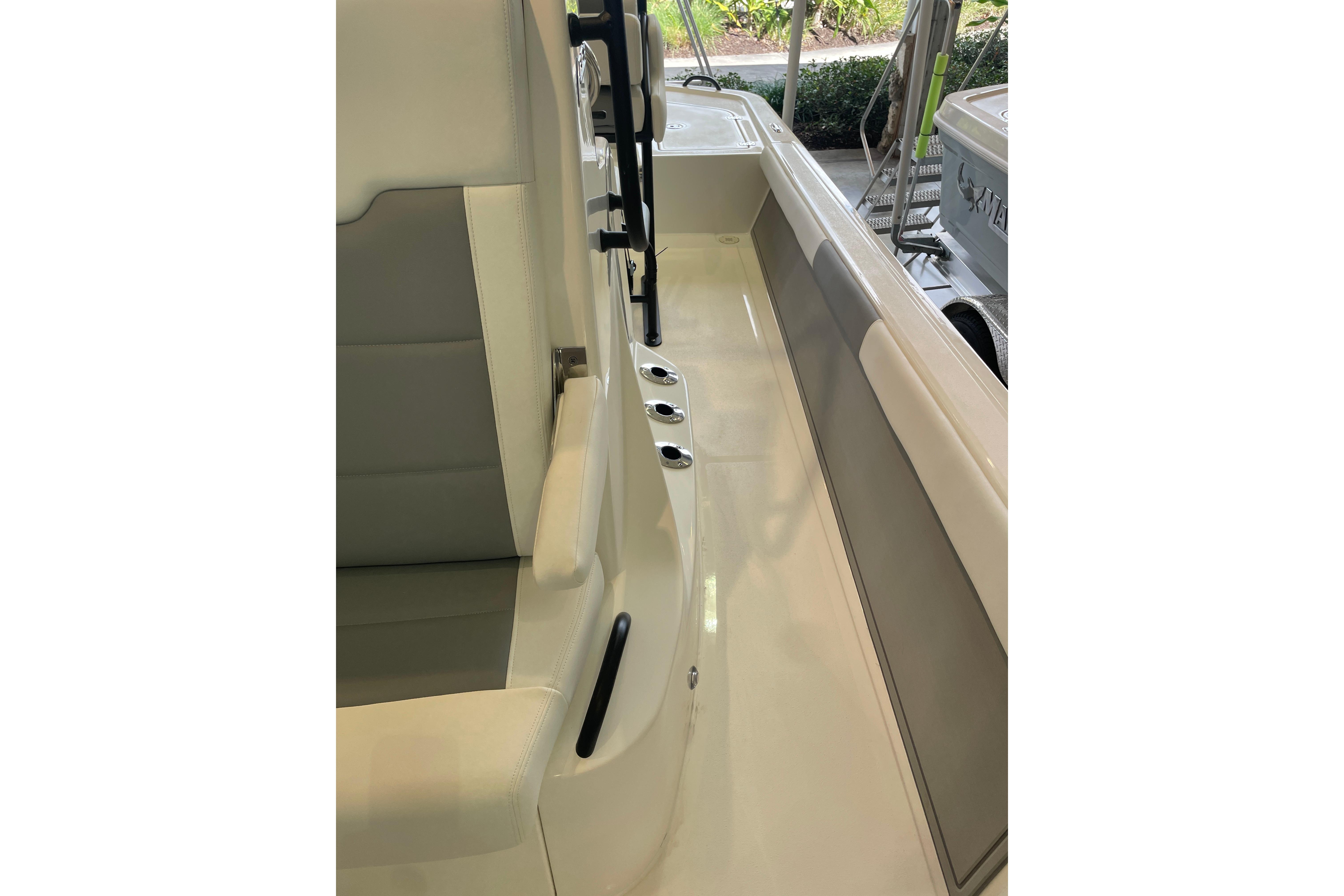 Interior view of 2026 Mako 24 APEX boat, featuring seating and deck details.