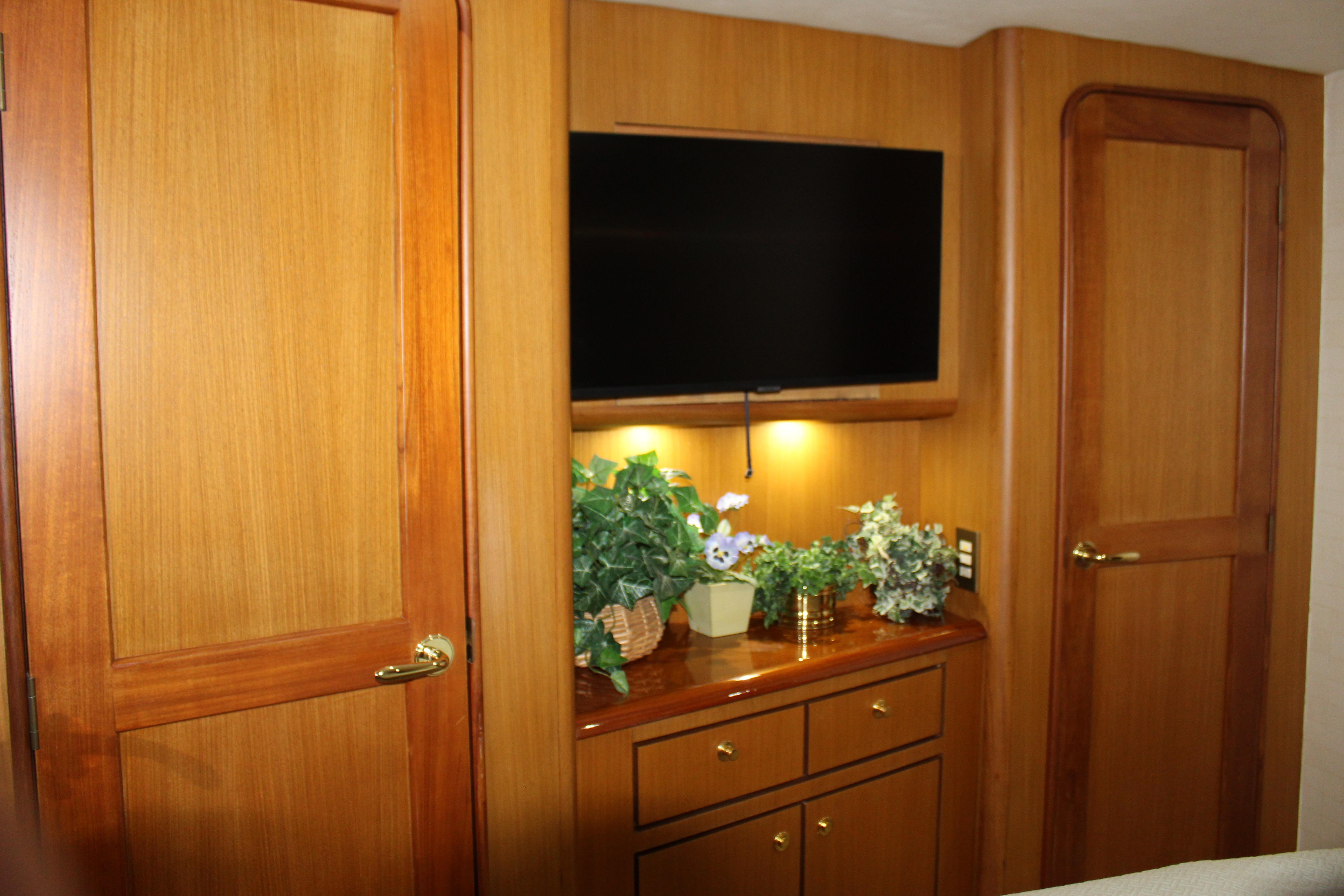 Luxurious interior of 2003 Ocean Yachts 65 Odyssey with wood paneling and TV.