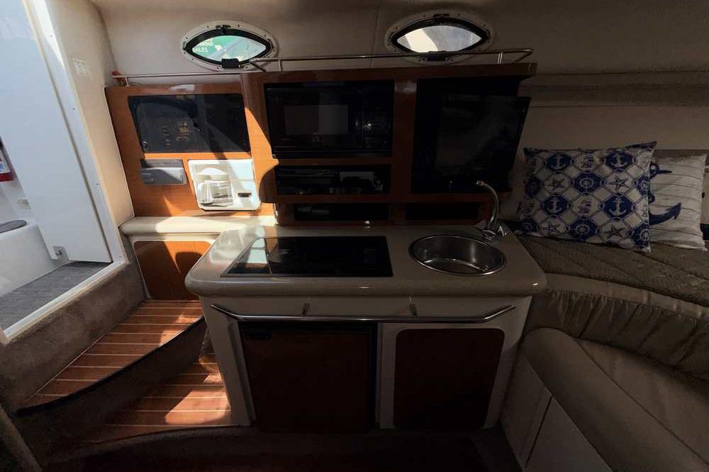 Interior of a 2001 Monterey 282 Cruiser boat with kitchenette and seating area.