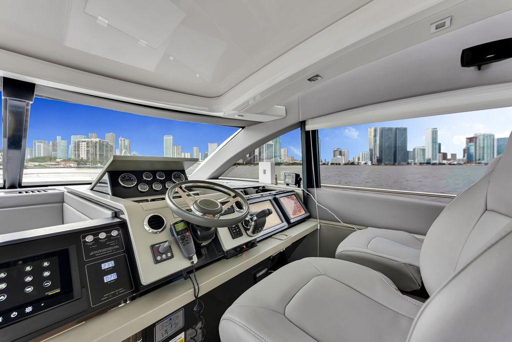 Interior of 2012 Fairline Targa 58 yacht with city skyline view through windows.