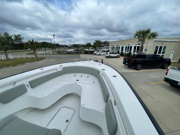 2026 Cape Horn 24XS boat in parking lot, cloudy sky, palm trees, and vehicles in background.