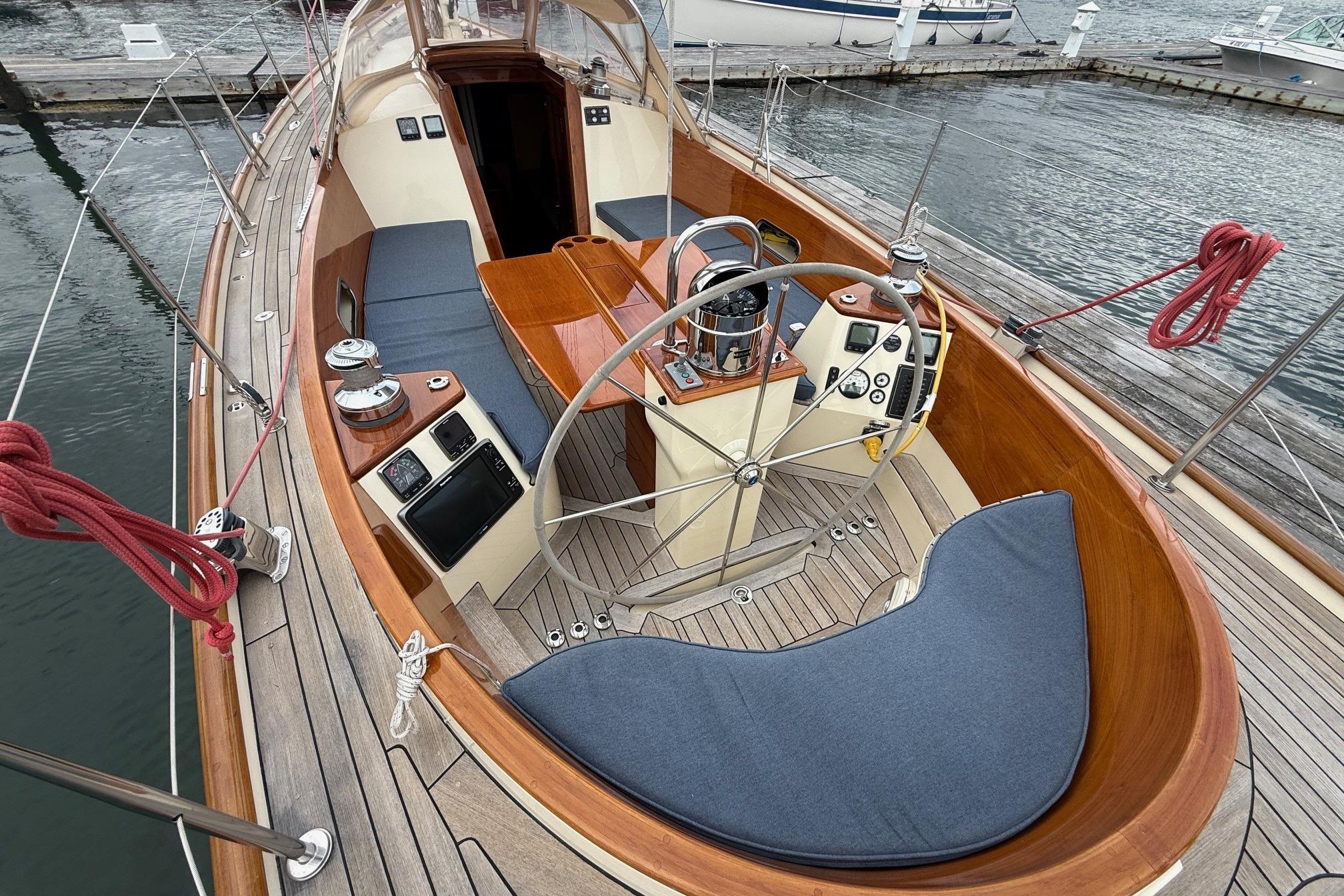 2015 Hinckley DS 42 sailboat cockpit with wooden deck and steering wheel.