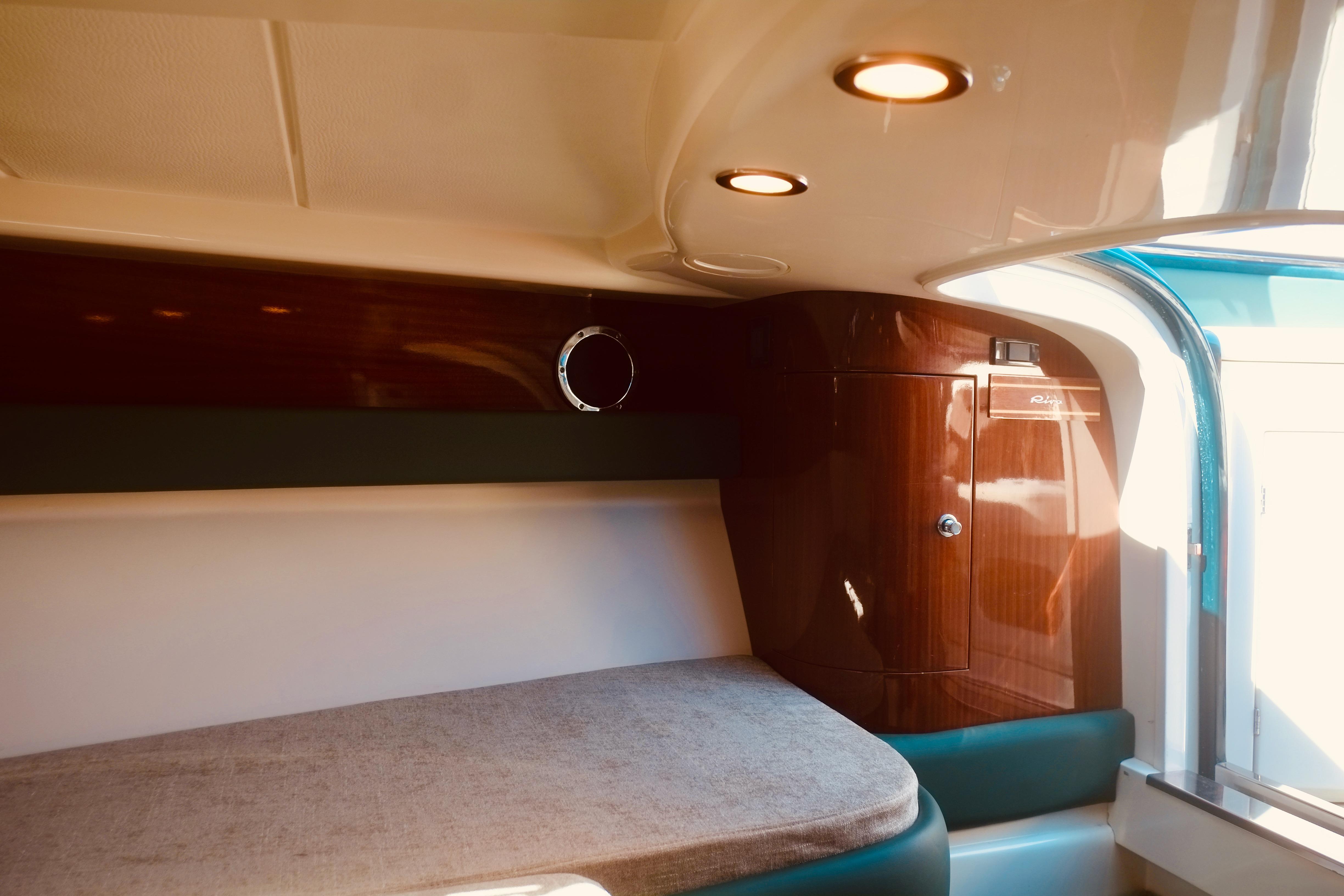 Luxurious interior of 2003 Riva Aquariva 33 with elegant wood finish and cozy seating.