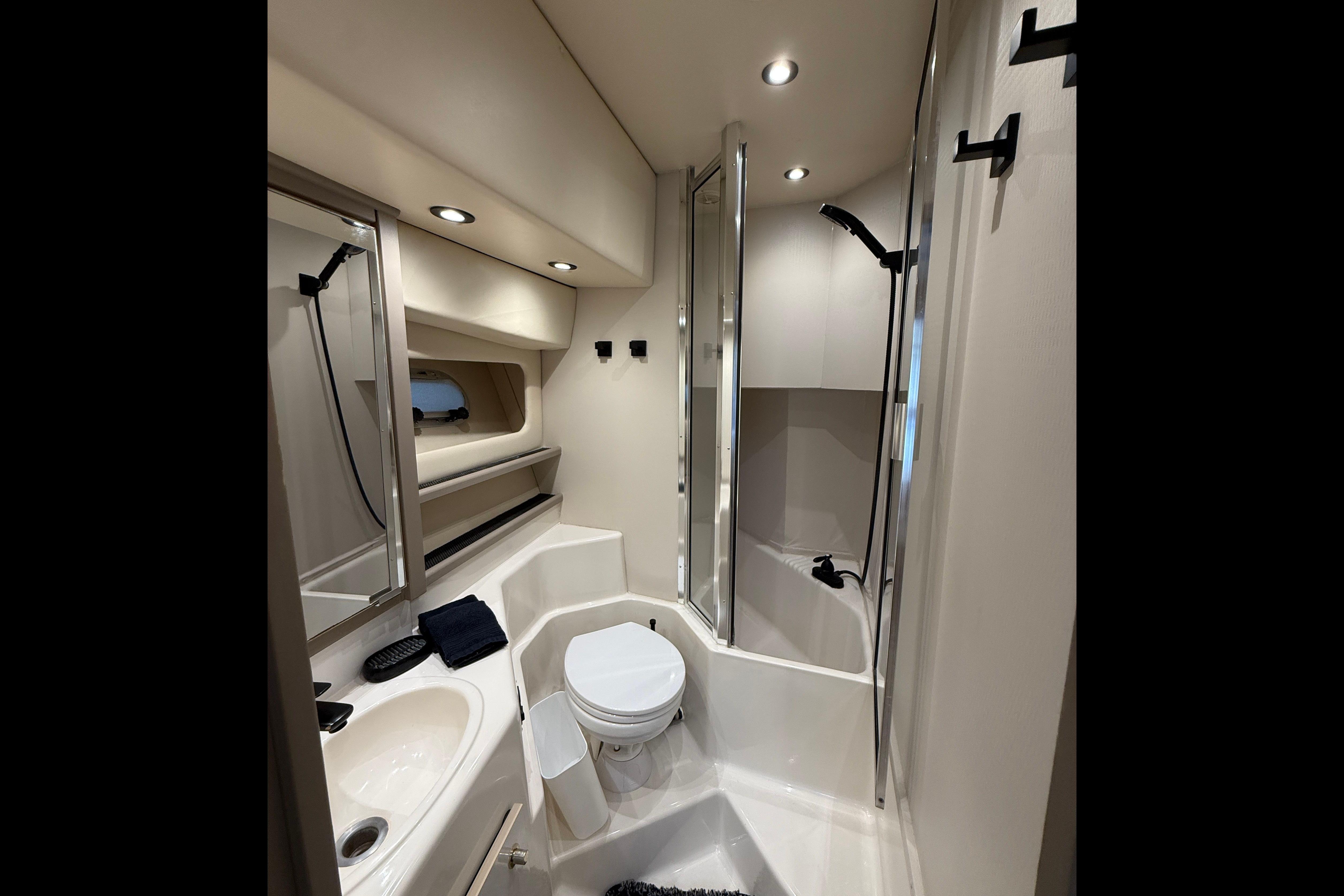 Bathroom interior of 1997 Bayliner 4788 Pilot House Motoryacht, featuring shower and toilet.