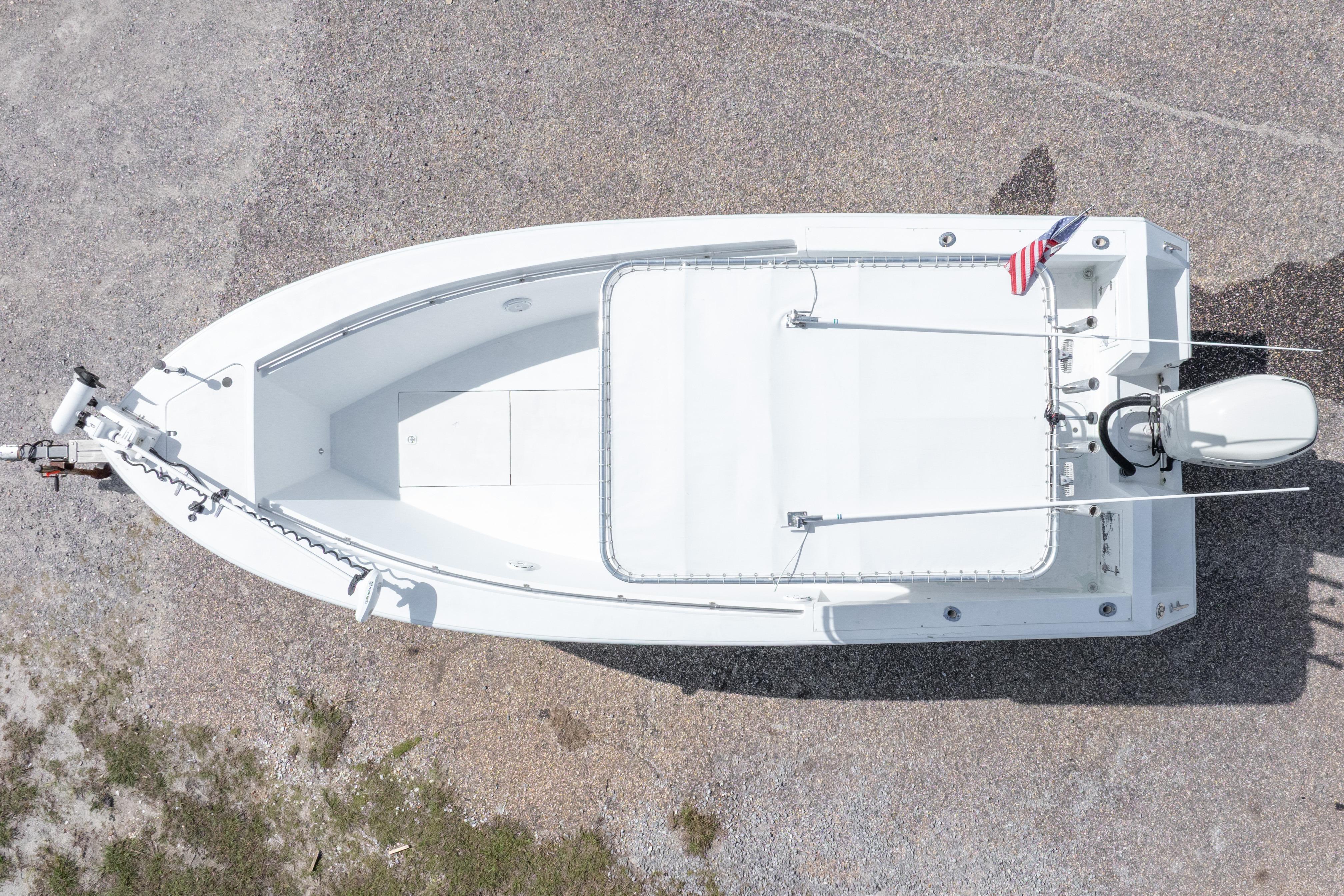 Overhead view of a 1998 Contender 21 CC boat on gravel, featuring a sleek white design.