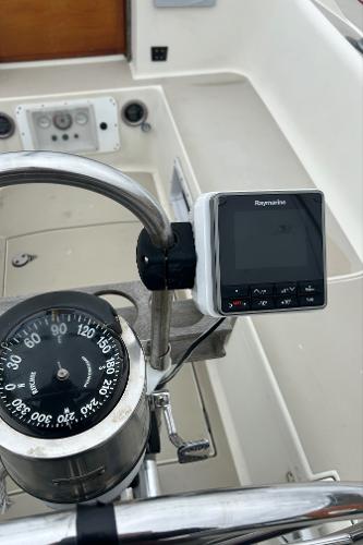 Cockpit of 1983 O'Day 39 sailboat with compass and Raymarine display.