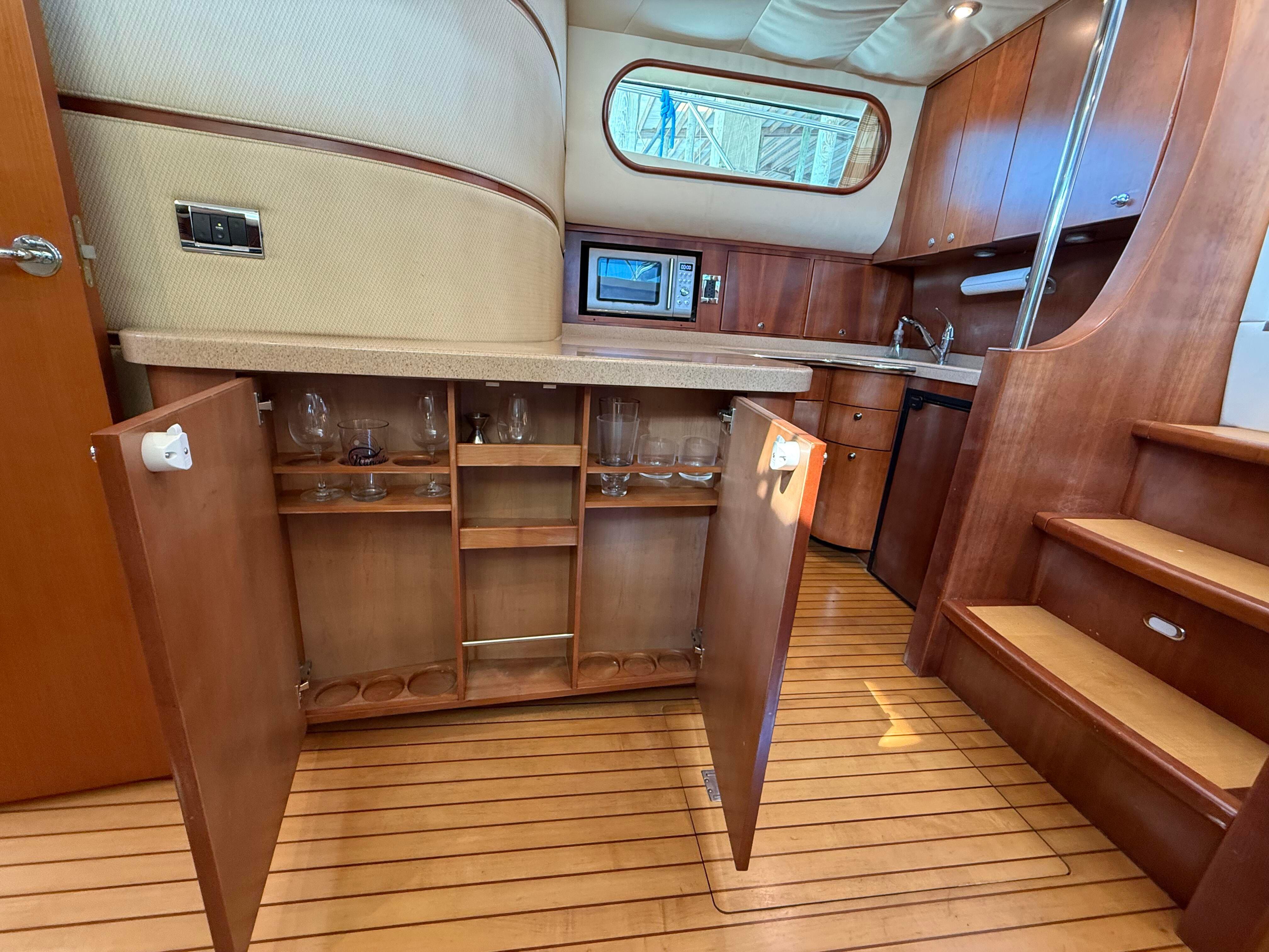 Interior of the 2007 Chris-Craft Roamer 40 with wooden floors and cabinets.