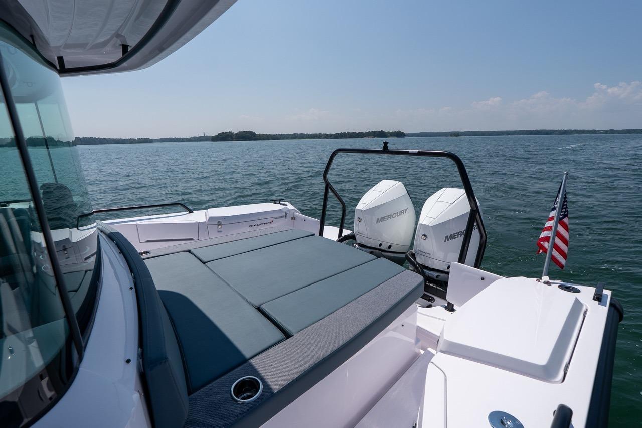2026 Axopar 37 XC boat with twin Mercury engines on a calm lake.