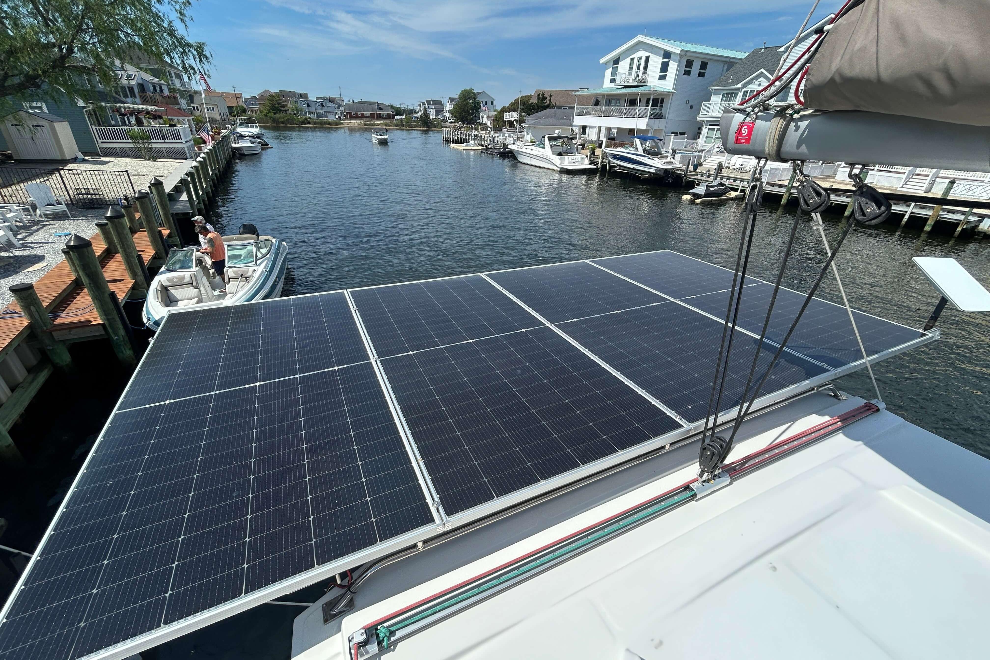 Solar panels on a Bali 4.1 catamaran, docked in a scenic marina, 2018 model.