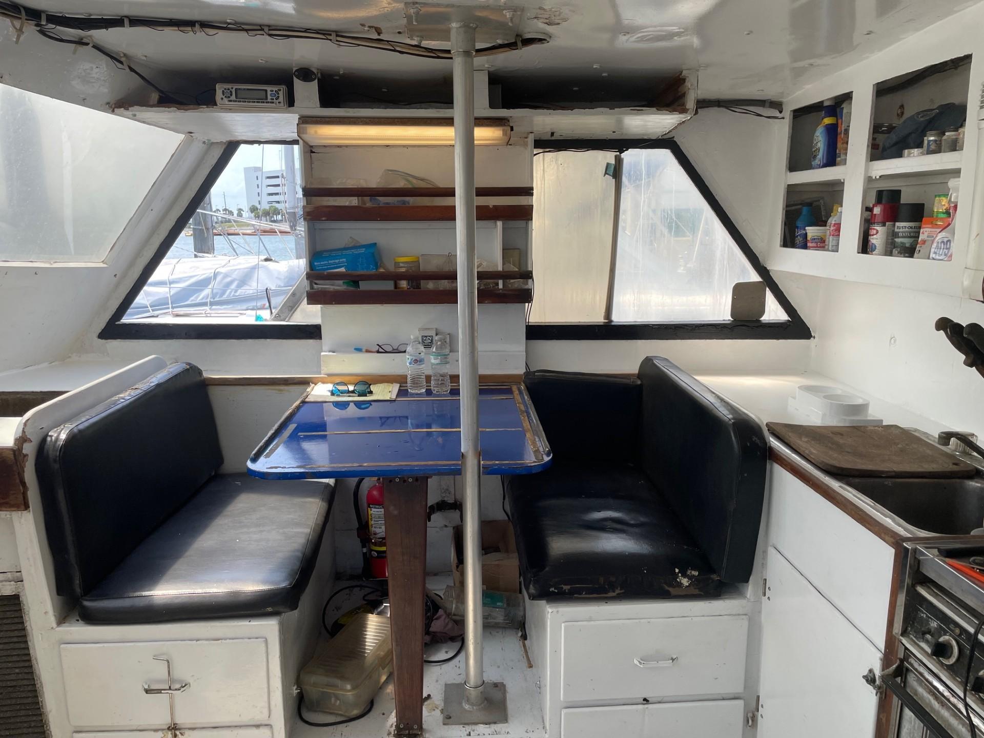 Interior of 1983 Commercial Hull #1 Key West boat with seating and kitchenette.