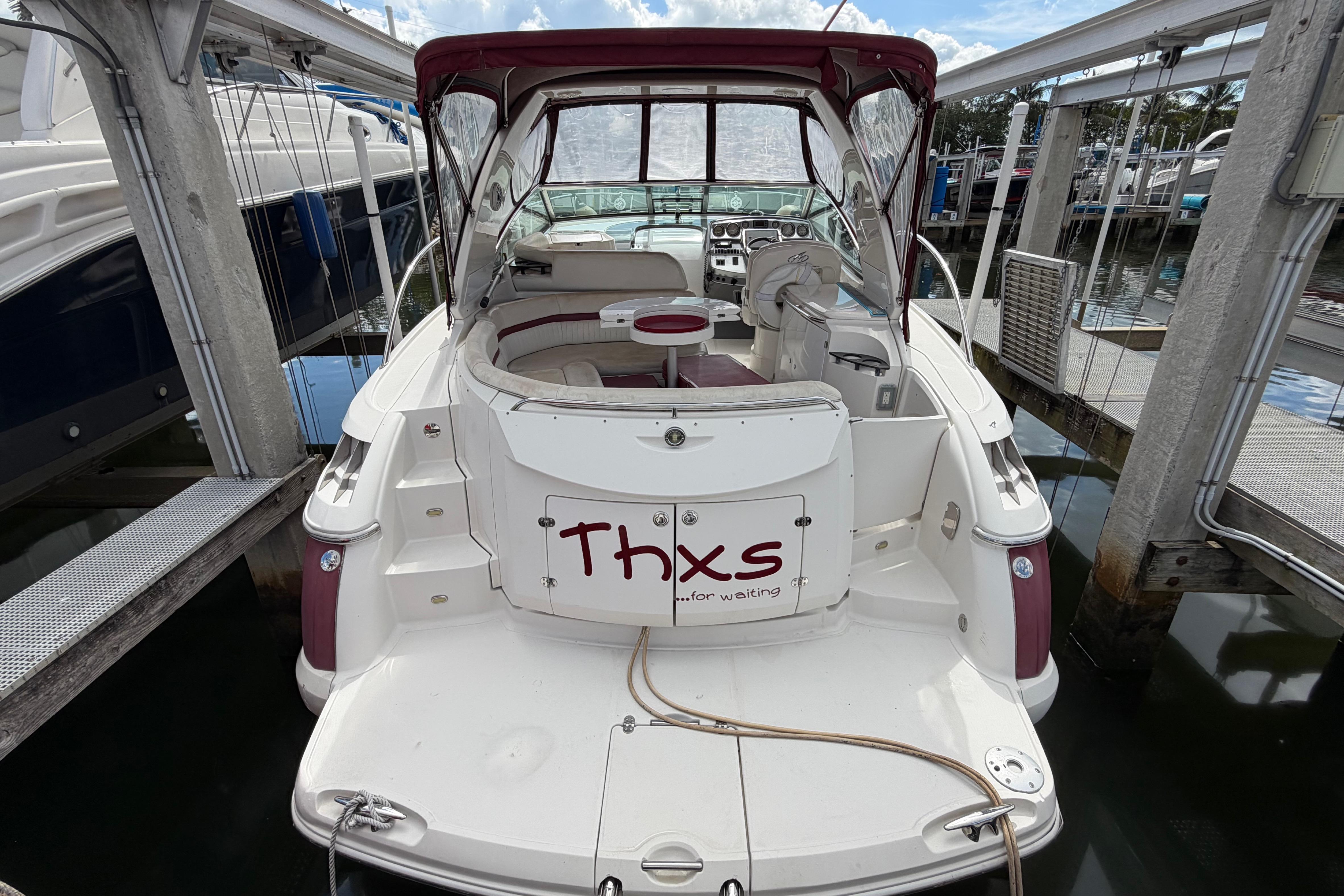 2007 Monterey 350 Sport Yacht docked, featuring spacious seating and "Thxs for waiting" sign.