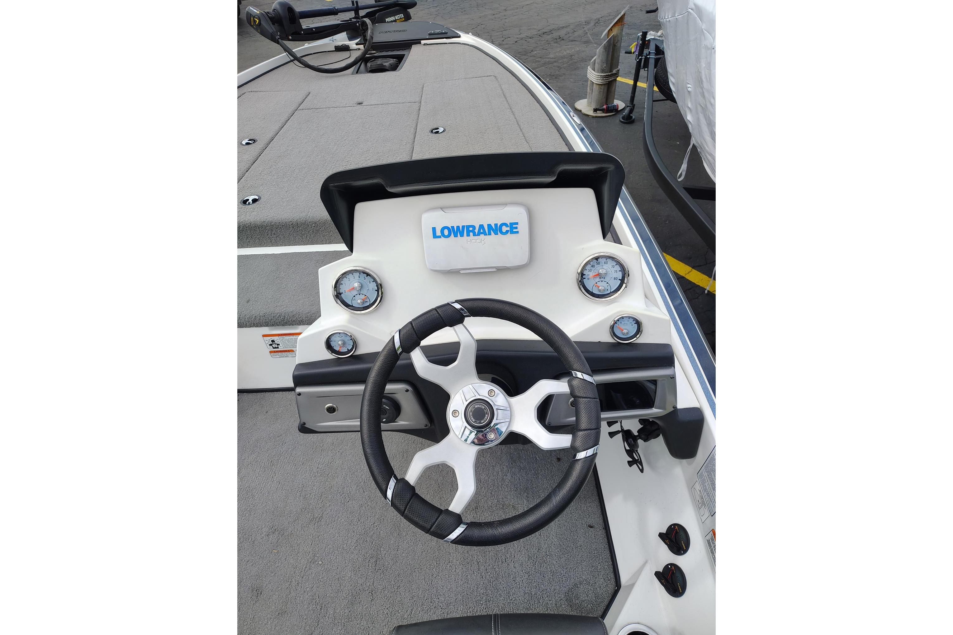 2024 Nitro Z20 boat dashboard with steering wheel and Lowrance display.