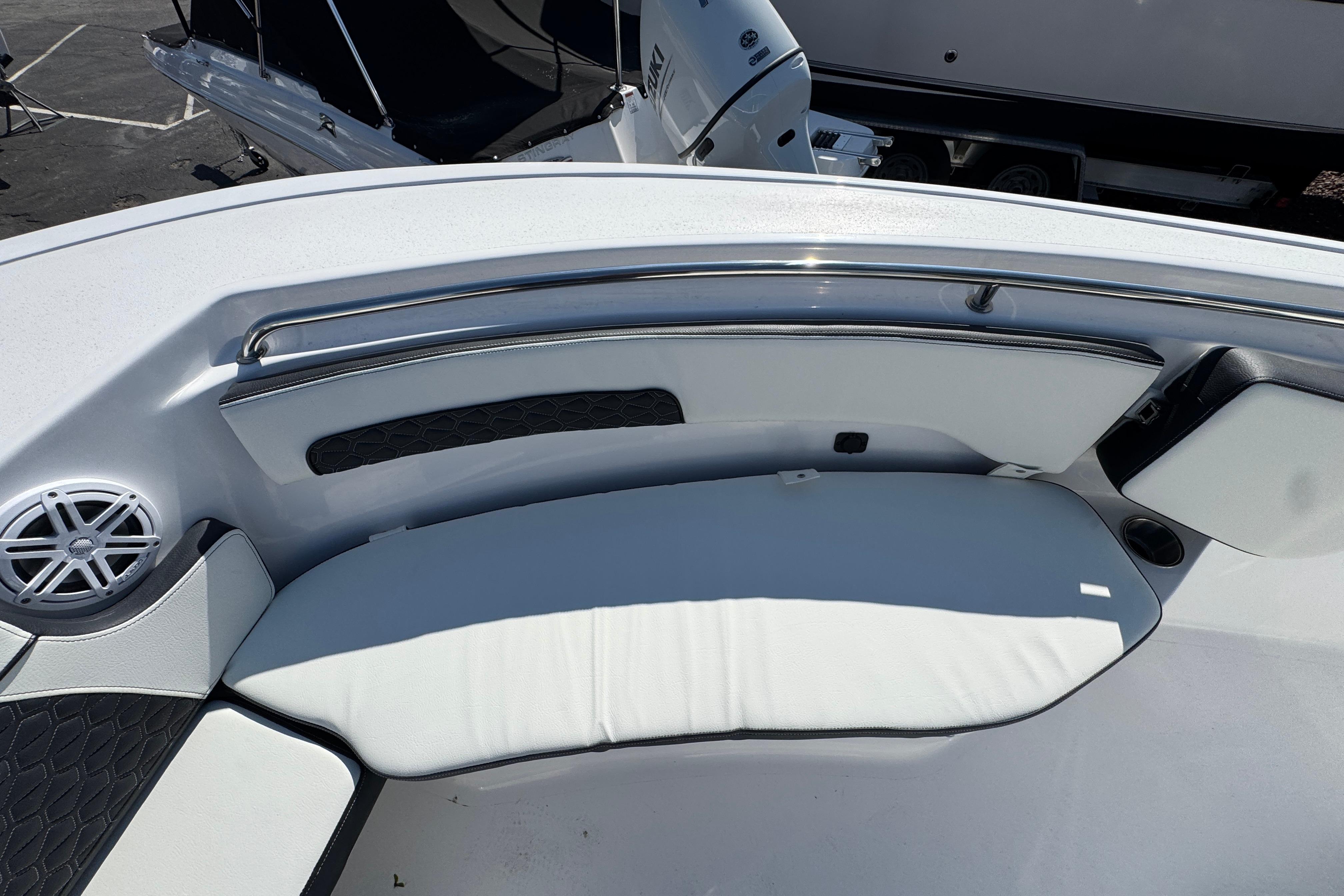 2026 Tidewater 220 CC Adventure boat interior with cushioned seating and speaker.