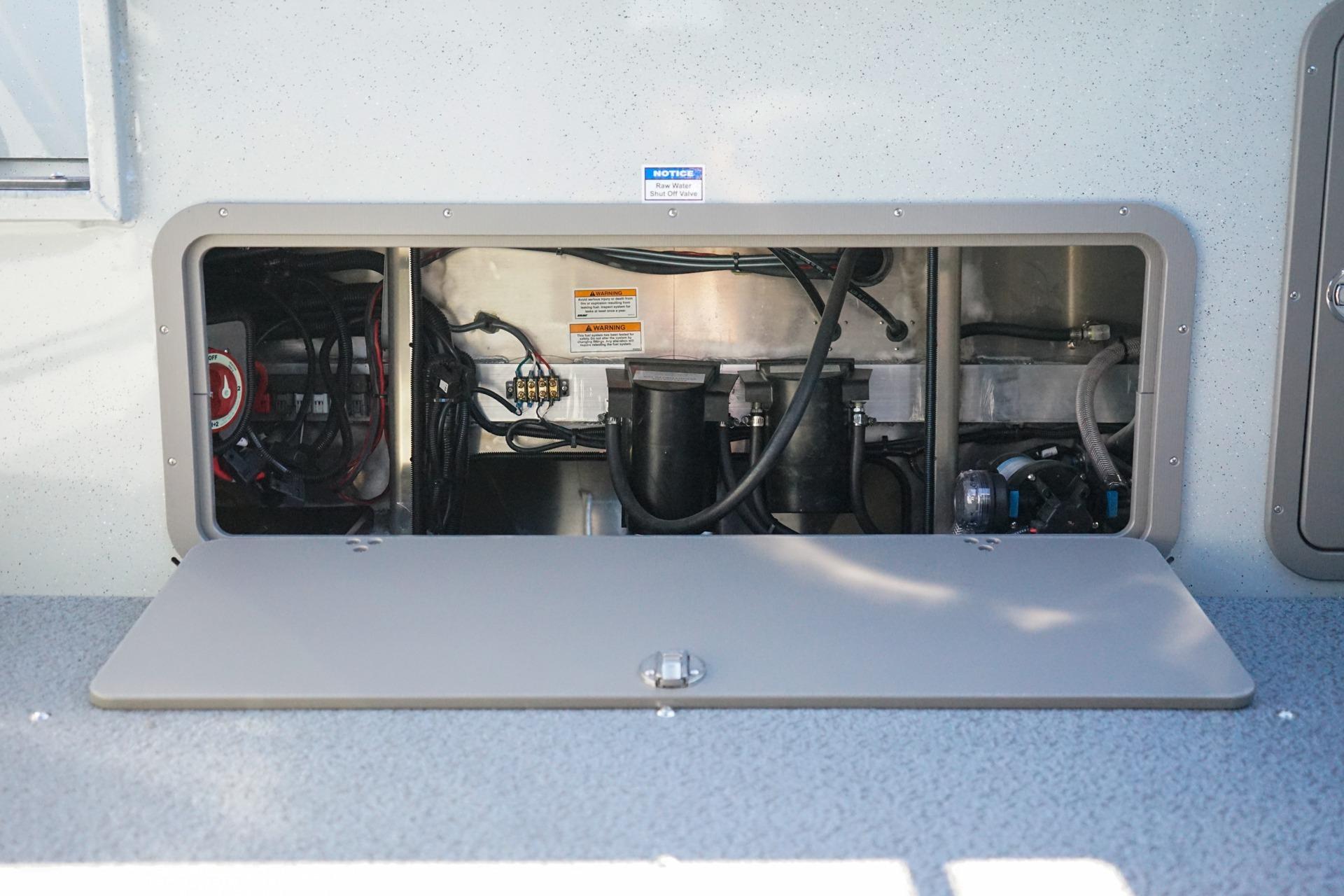 Open compartment of 2026 Weldcraft 210 Revolution boat showing internal wiring and components.