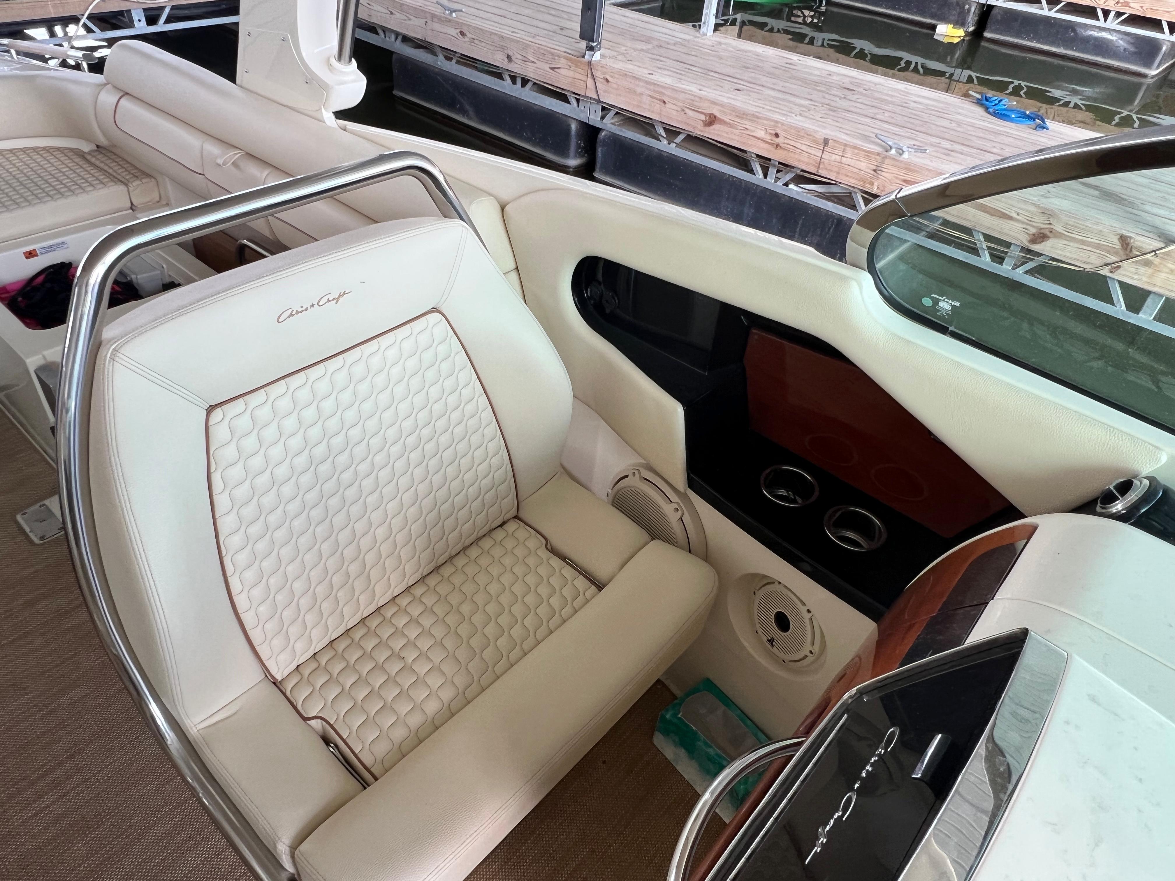 2020 Chris-Craft Launch 31 GT interior with white leather seating and dashboard details.