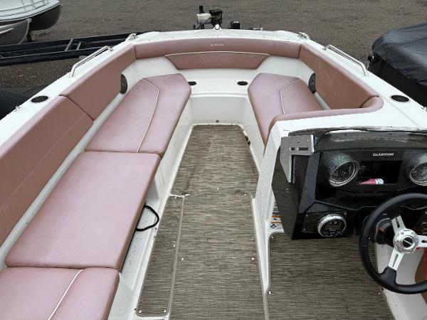 2017 Glastron 205 boat interior with beige seating and steering console.