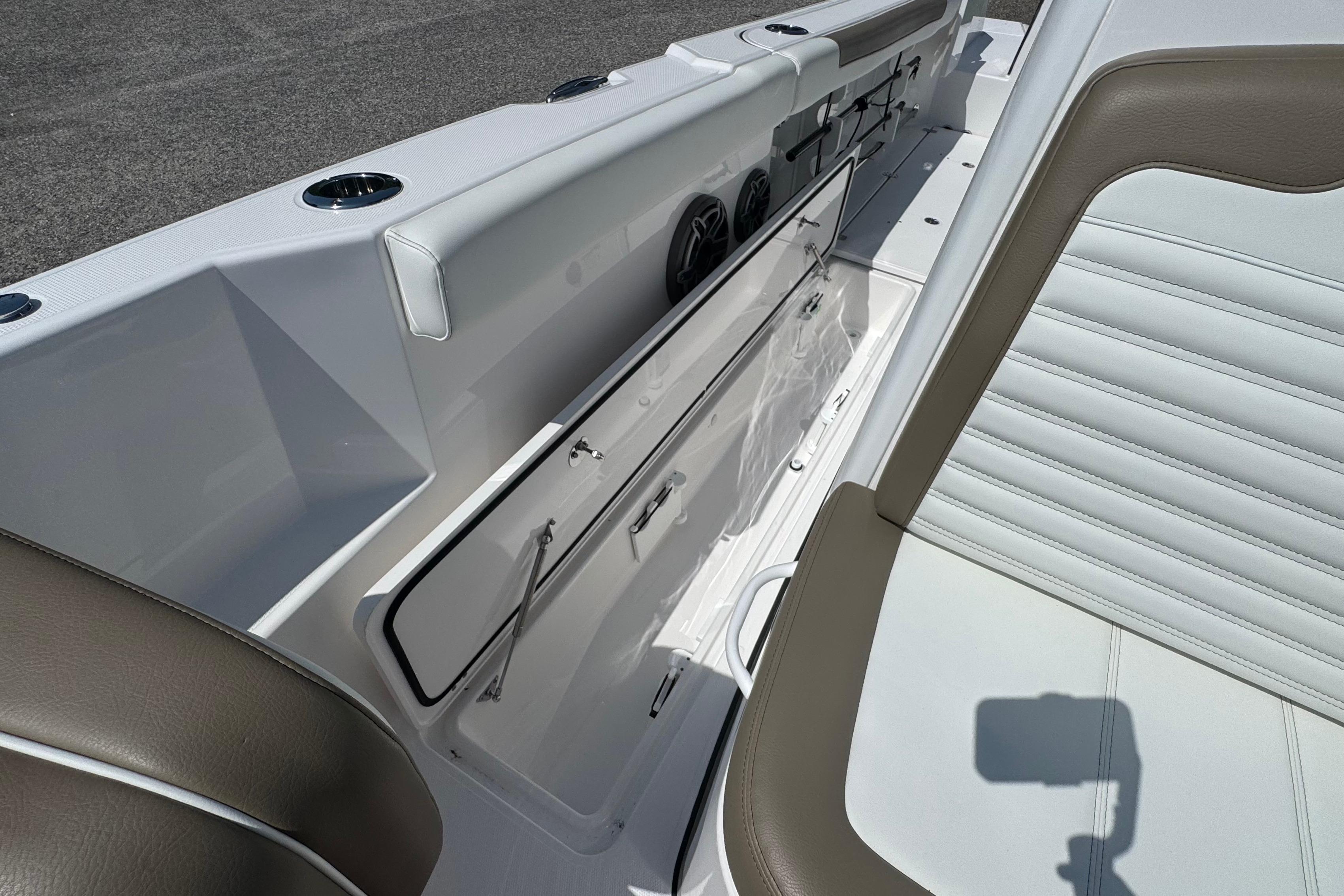 Interior view of 2026 Edgewater 250CC boat, featuring sleek seating and storage compartments.