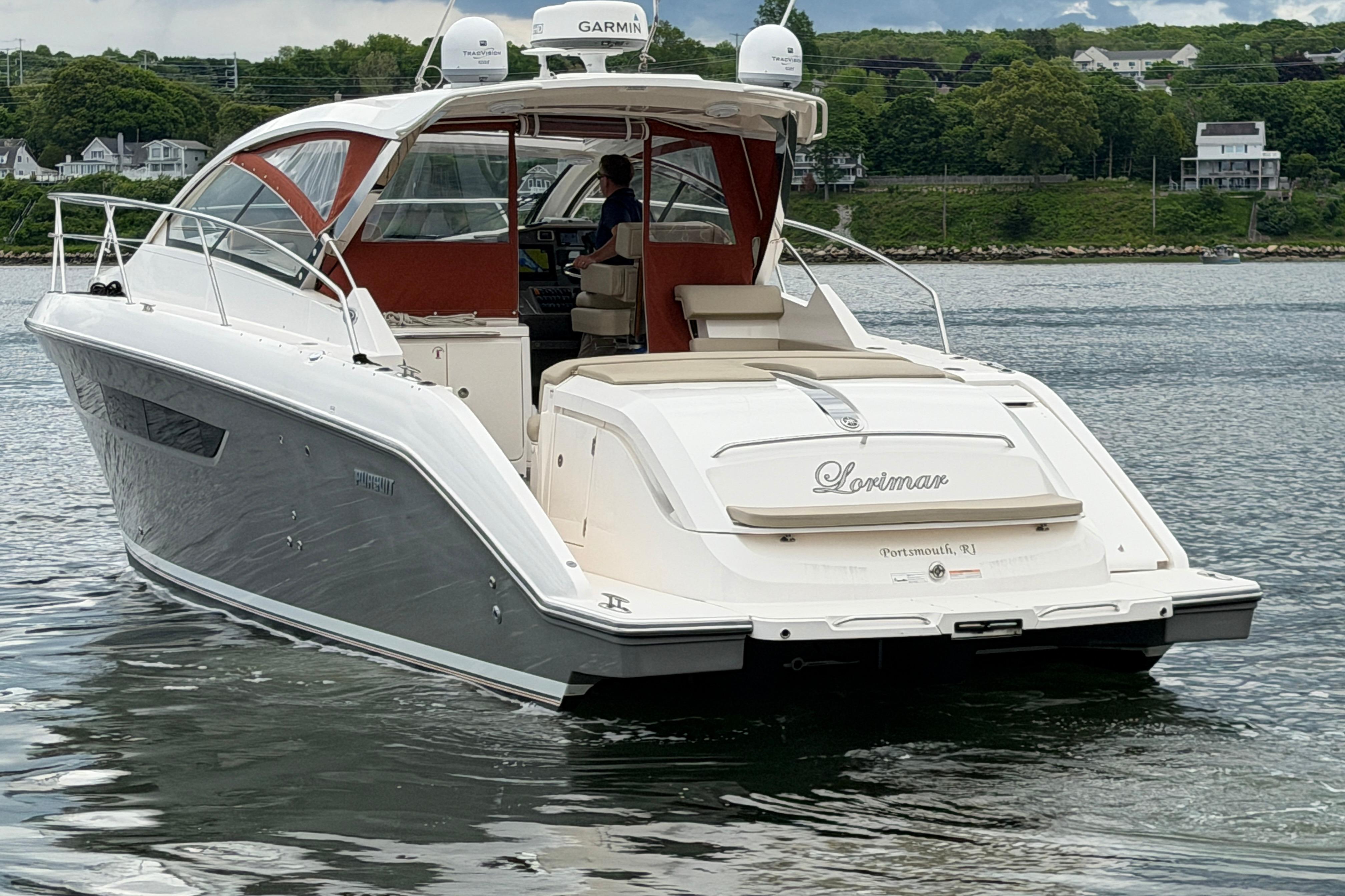 2016 Pursuit SC 365i Sport Coupe yacht on calm water, scenic background.