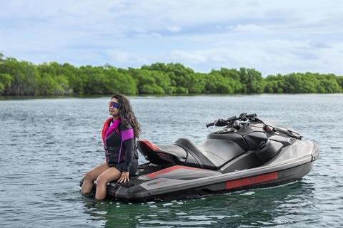 Woman on 2026 Sea-Doo GTR-X 300 jet ski in scenic water setting.