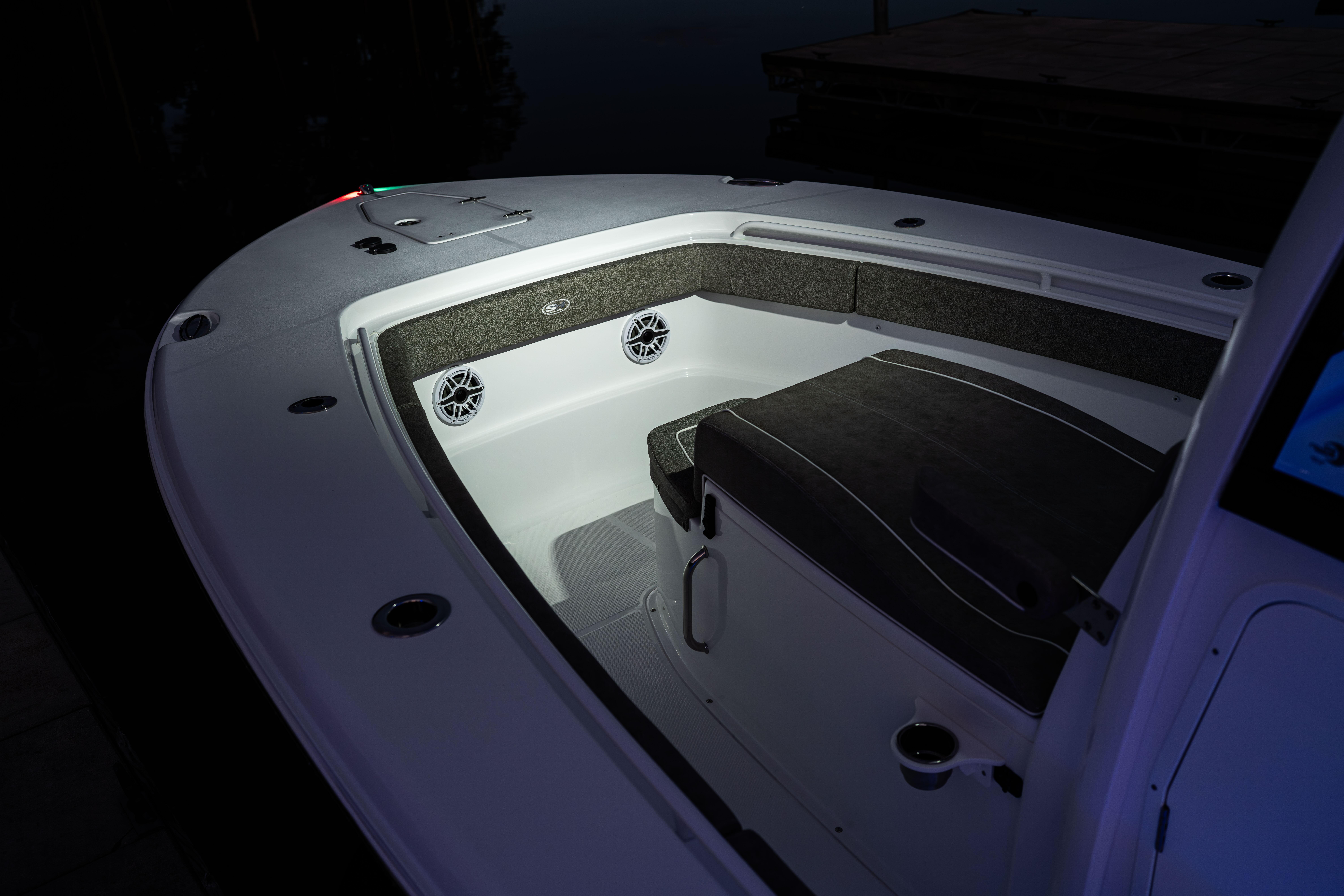2026 Sea Hunt Ultra 275 Coffin Box boat interior with cushioned seating and speakers.