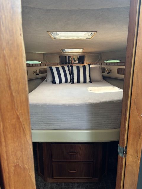 Interior of 1986 Sea Ray 360 Aft Cabin yacht with cozy bed.