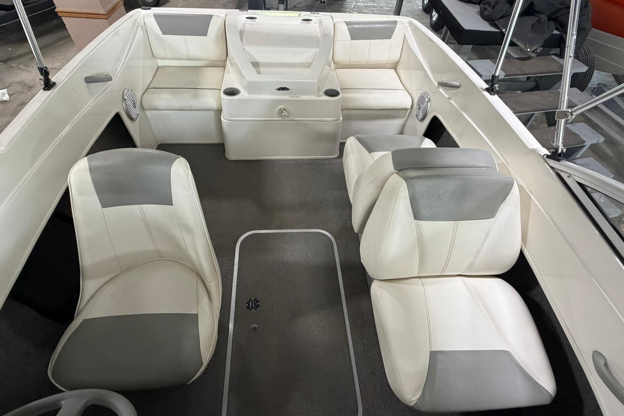 Interior of a 2012 Bayliner 175 Bowrider boat with white and gray seating.