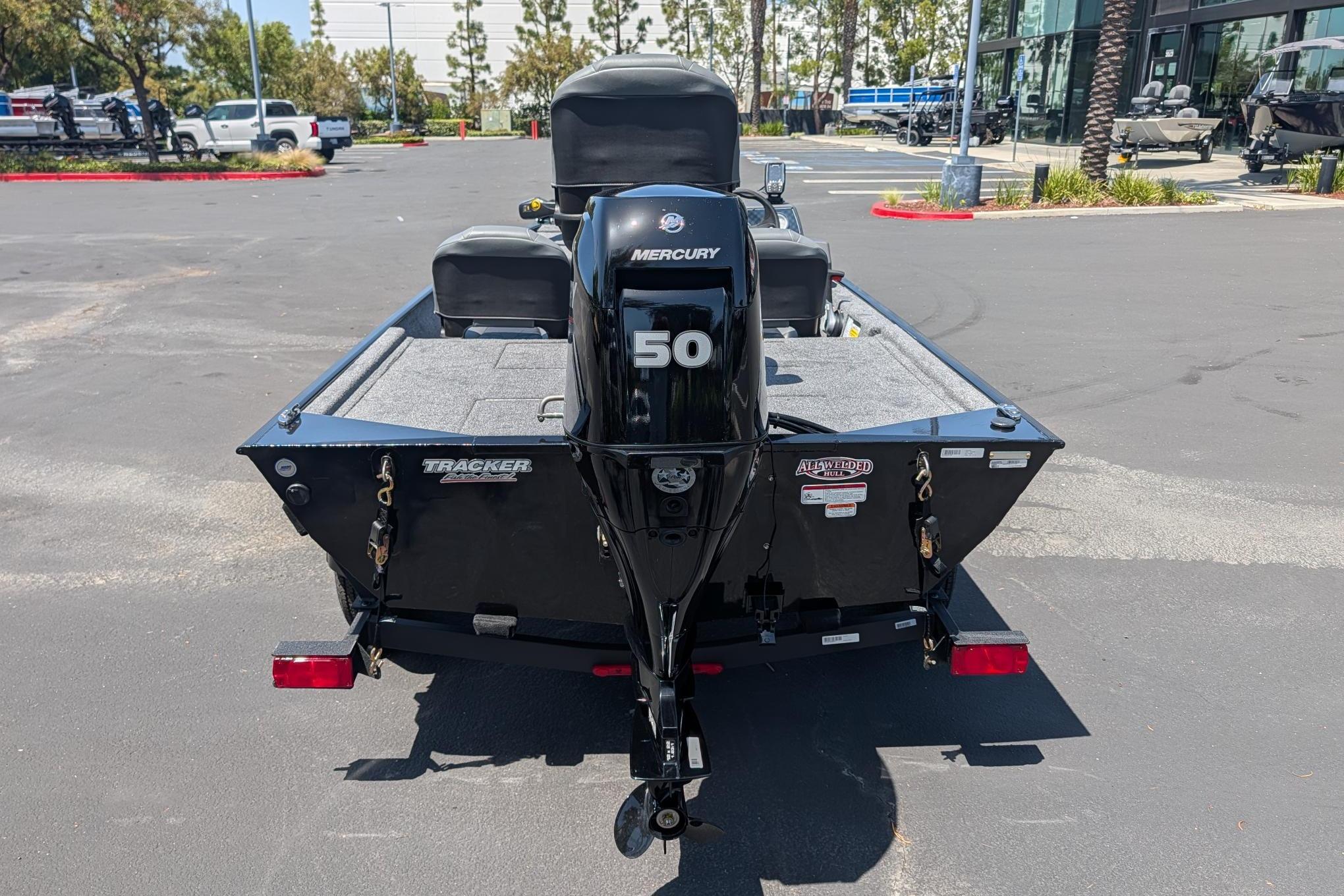 2026 Tracker Bass Tracker Classic XL boat with Mercury 50 engine in parking lot.