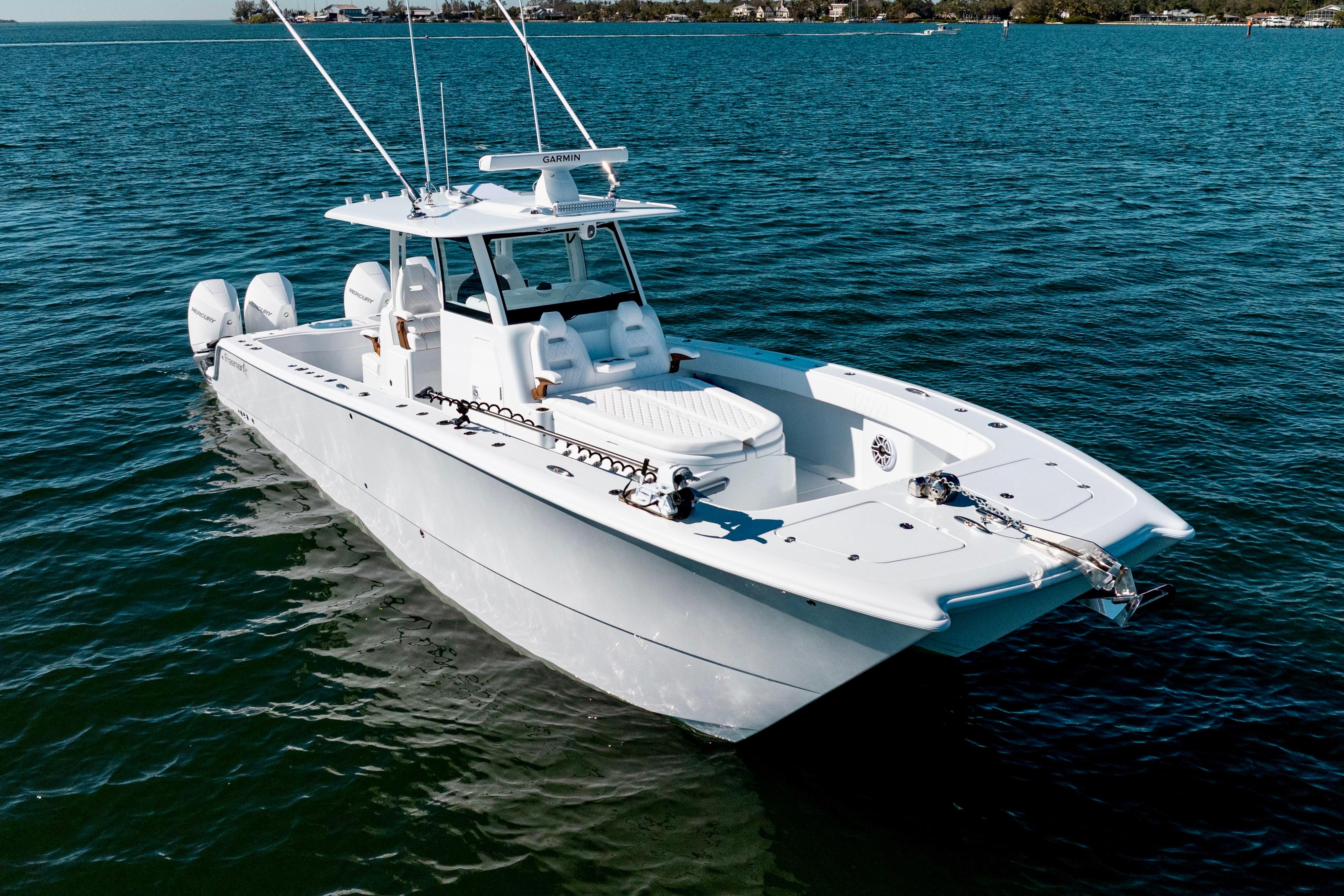 2026 Freeman 35 boat on calm blue water, featuring twin engines and sleek design.