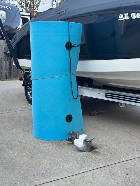 2008 Chaparral Sunesta 244 Xtreme with blue boat fender on concrete.