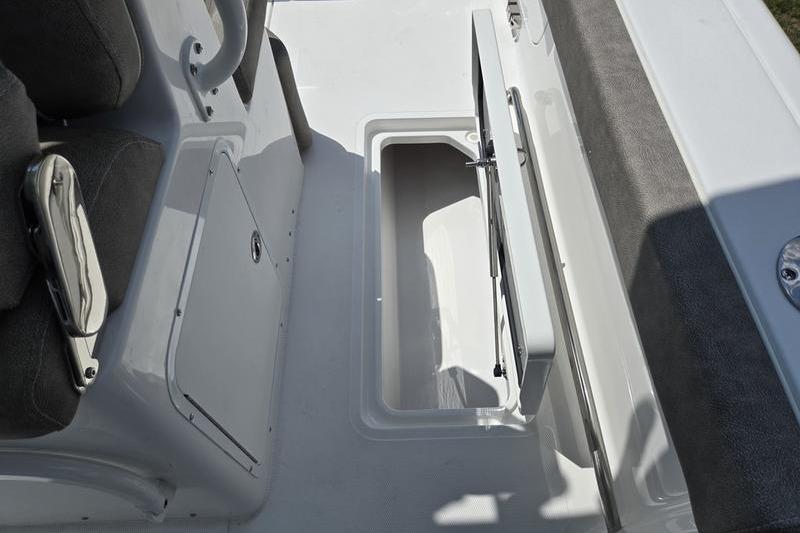 2027 Sea Hunt Ultra 275 SE boat interior storage compartment open.