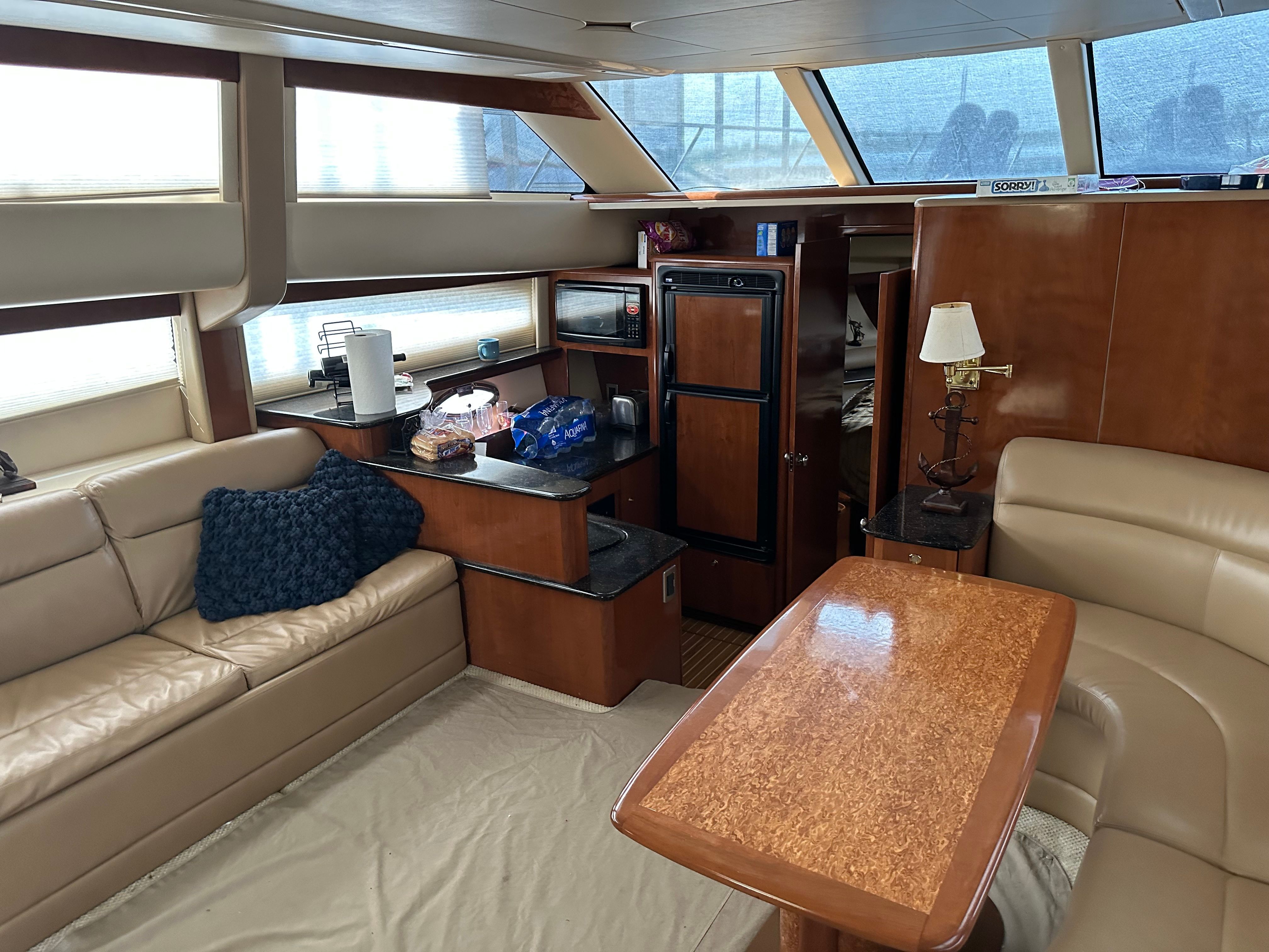 Interior of a 2007 Meridian 459 Motoryacht with leather sofas and wooden table.