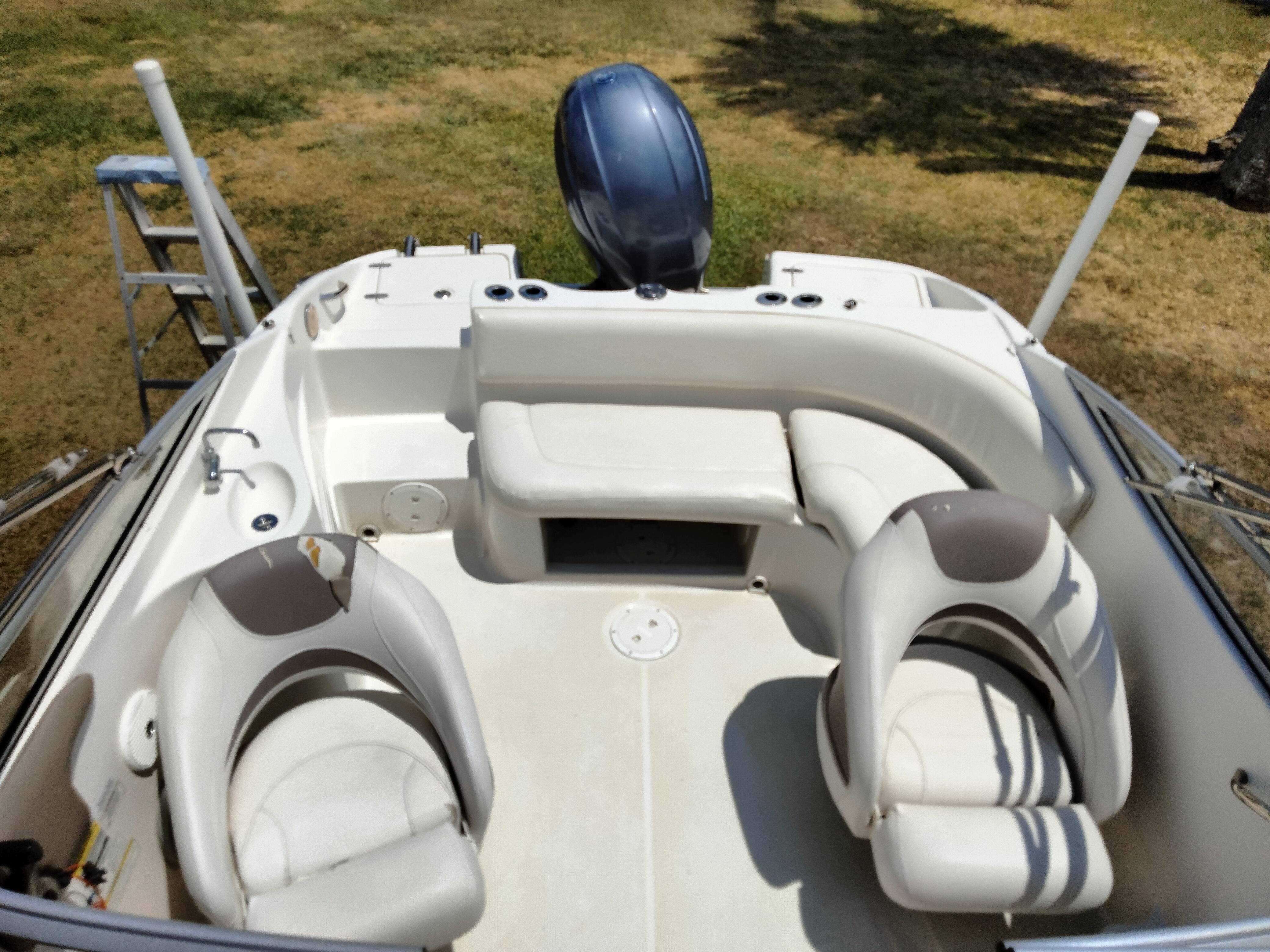 2016 SouthWind 212 SD boat interior with seating and motor.