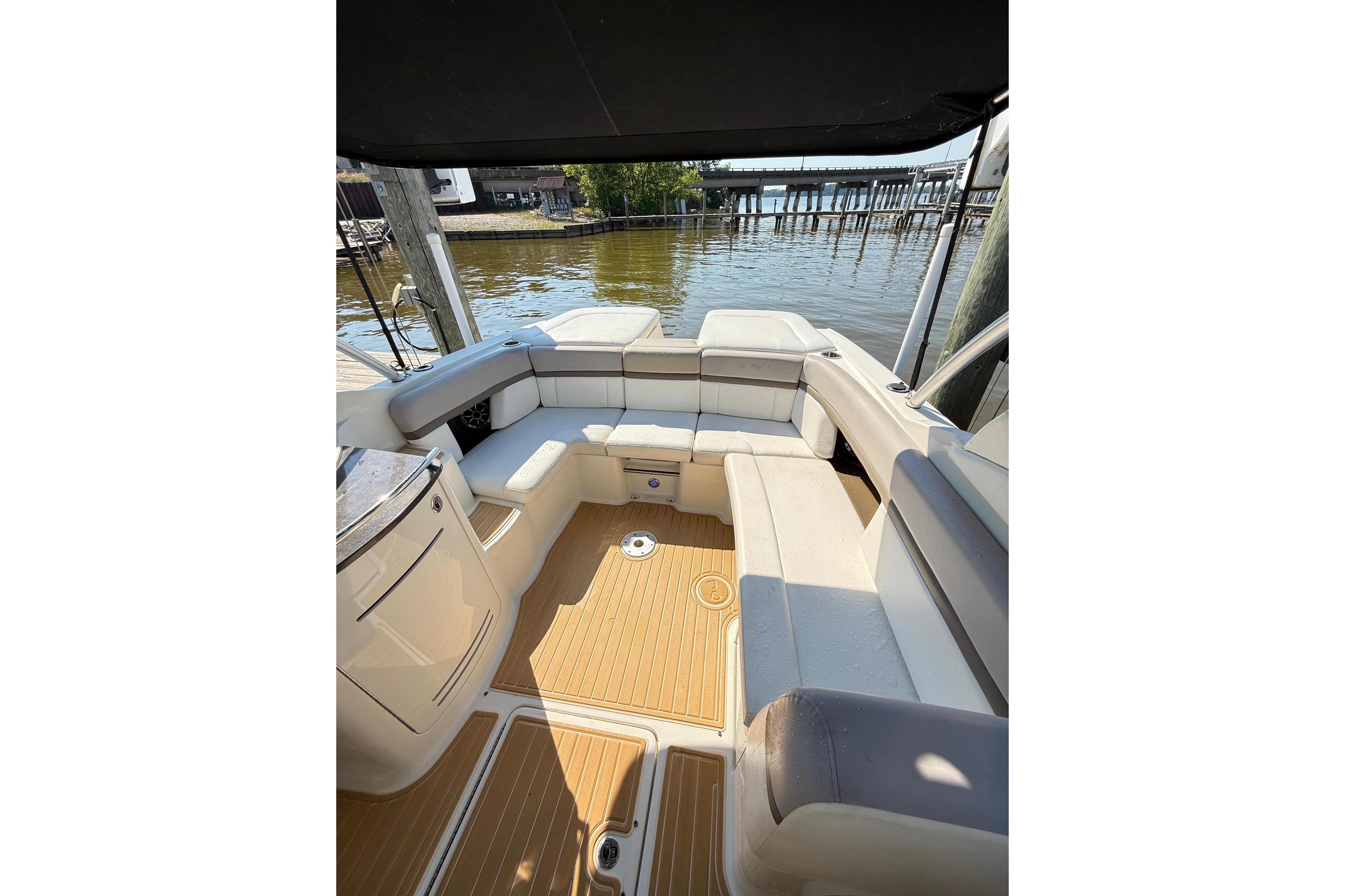 2011 Sea Ray 270 SLX boat interior with cushioned seating and wooden flooring.