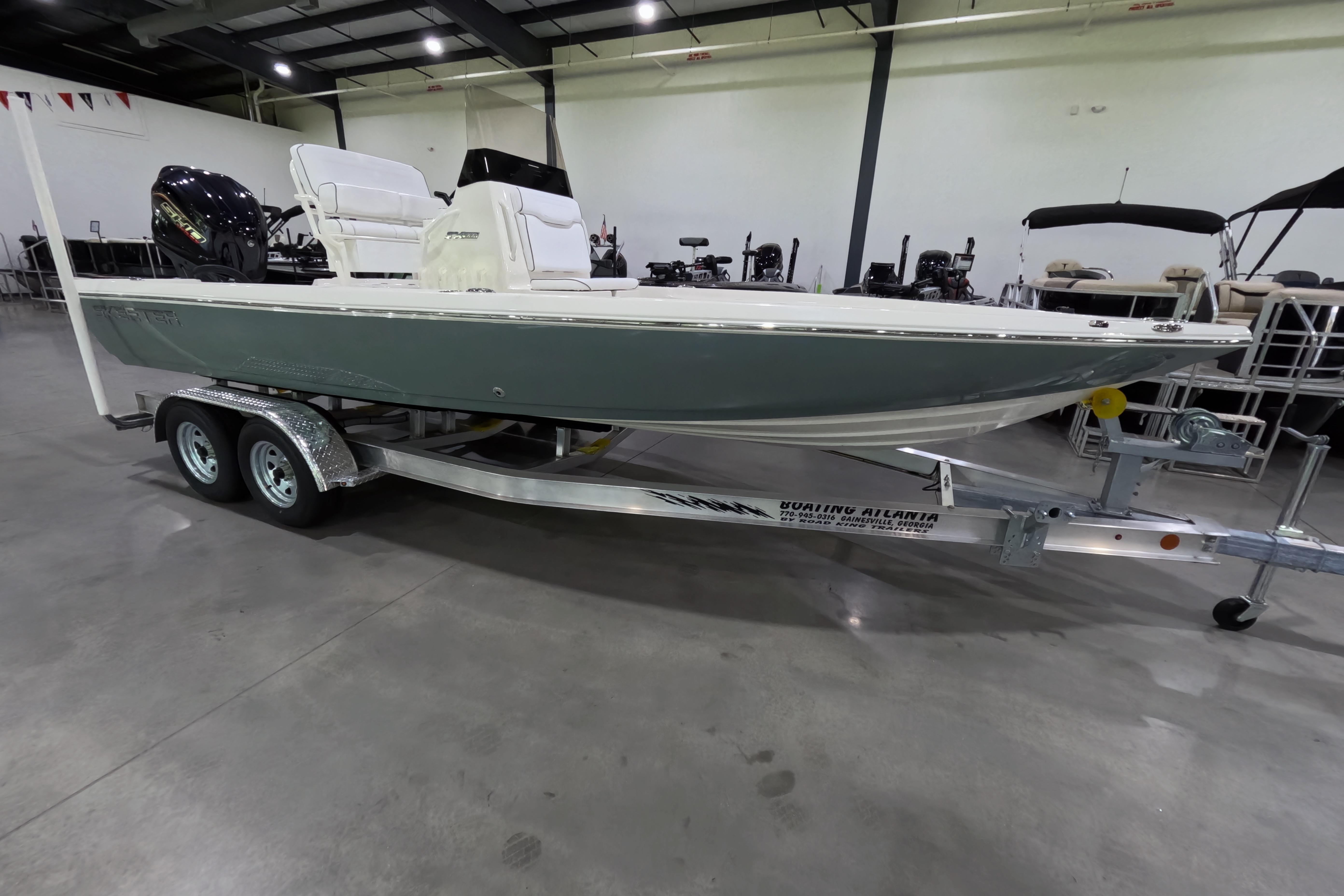 2026 Skeeter boat on trailer in showroom, featuring sleek design and modern outboard motor.
