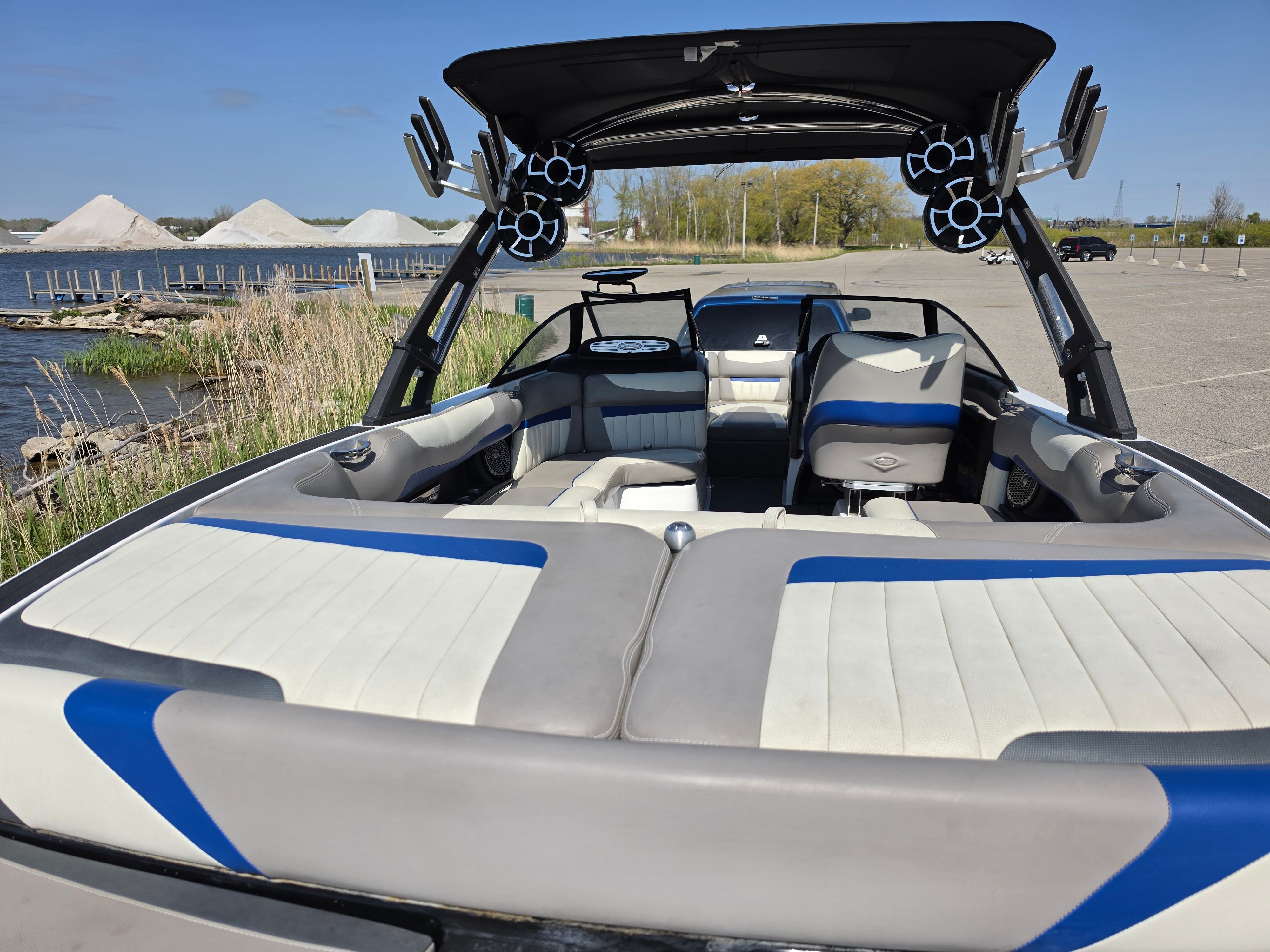 2014 Malibu Wakesetter 24 MXZ boat by the water with speakers.
