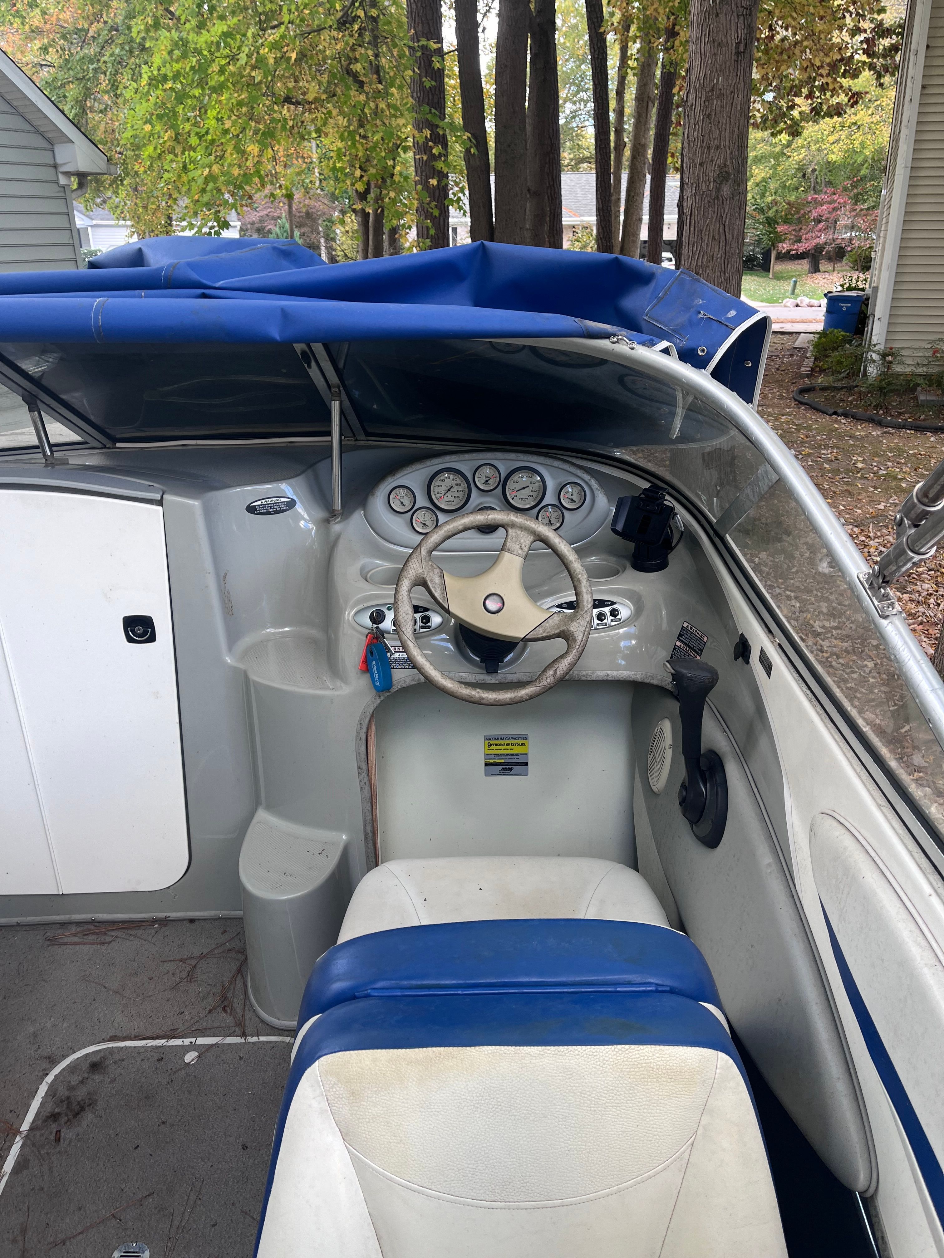 Interior of a 2005 Bayliner Cuddy Capri with blue canopy.
