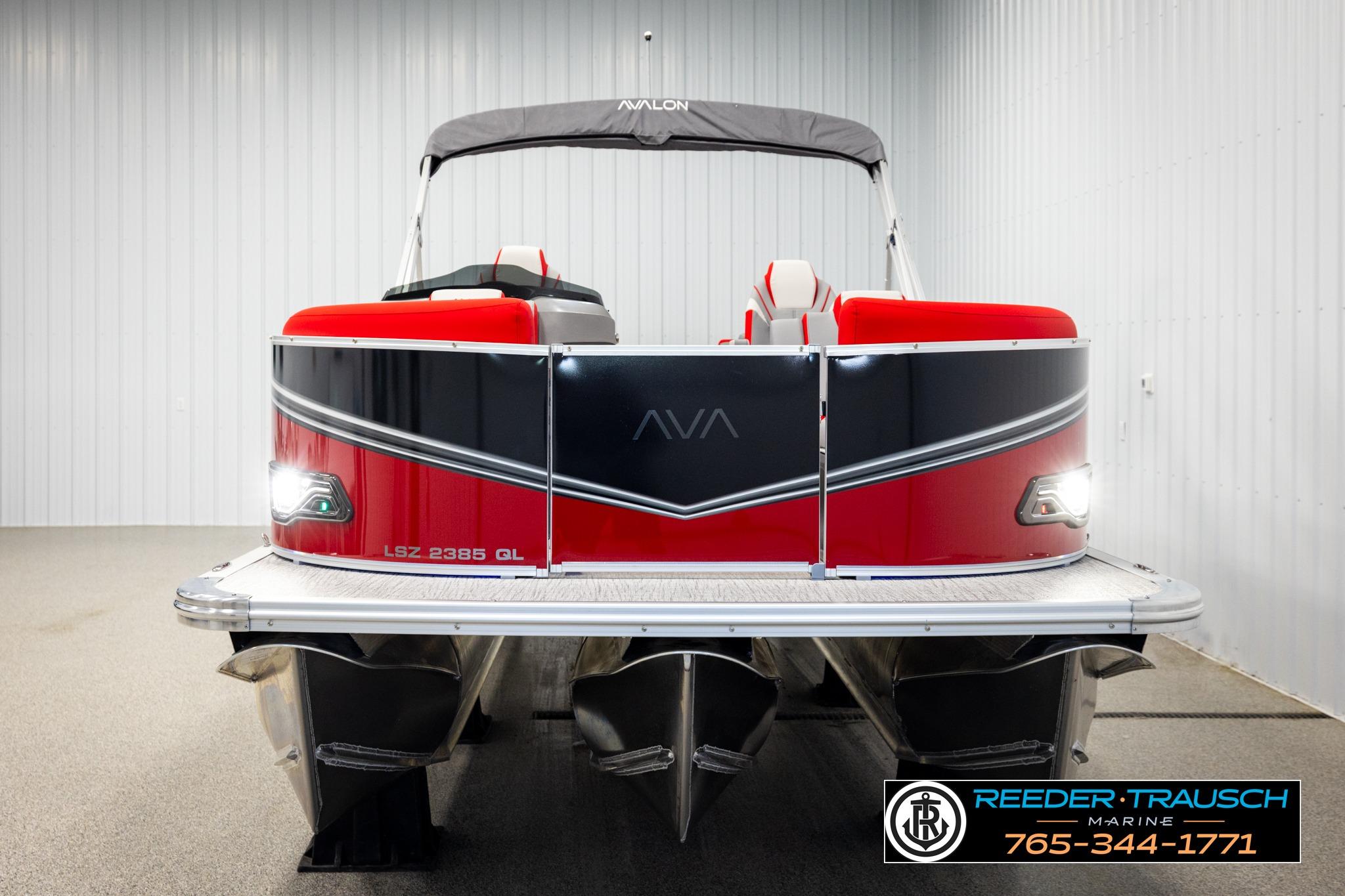 2026 Avalon LSZ QL pontoon boat, red and black design, displayed indoors at Reeder-Trausch Marine.