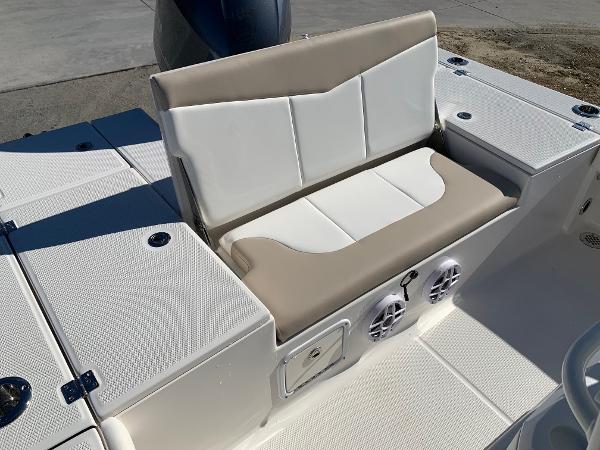2024 Robalo 226 Cayman boat seating area with storage compartments and speakers.